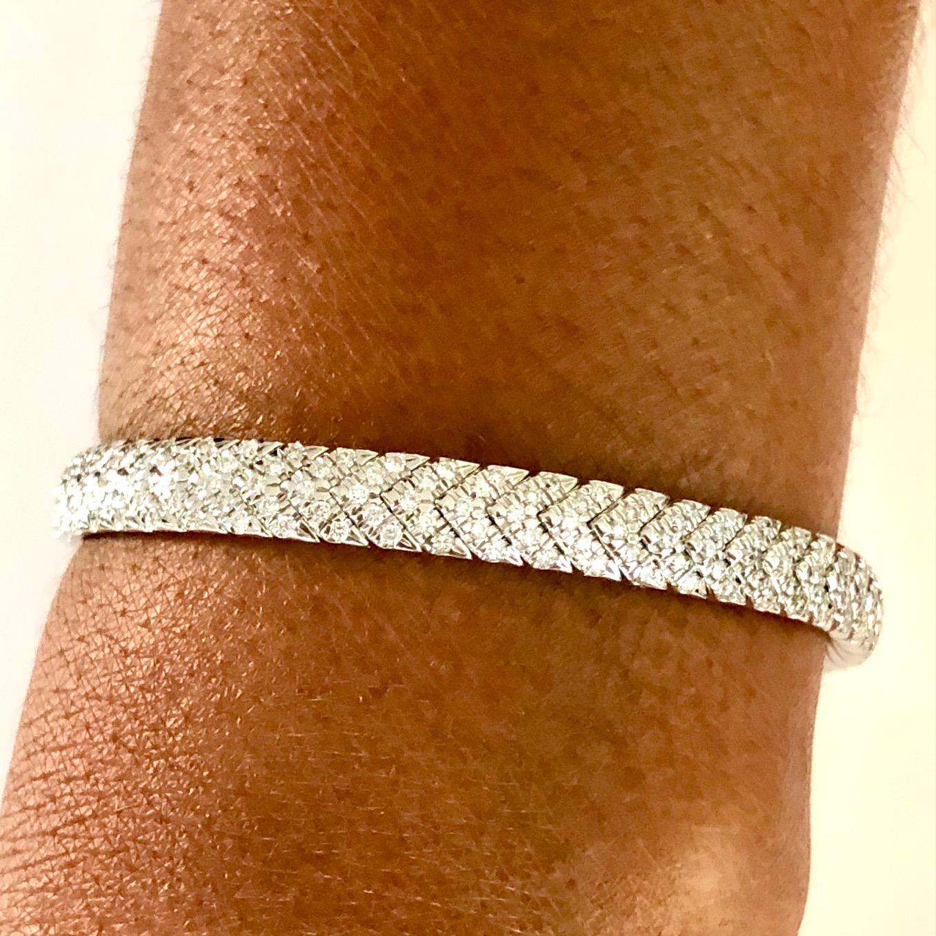 Soft, comfortable and stylish, this flexible Diamond Bangle Bracelet is the perfect all day accessory, set with 250 round Diamonds 2.58 carats.
Available also in 18K Yellow Gold.

We design and manufacture our jewelry in our workshop, located in New