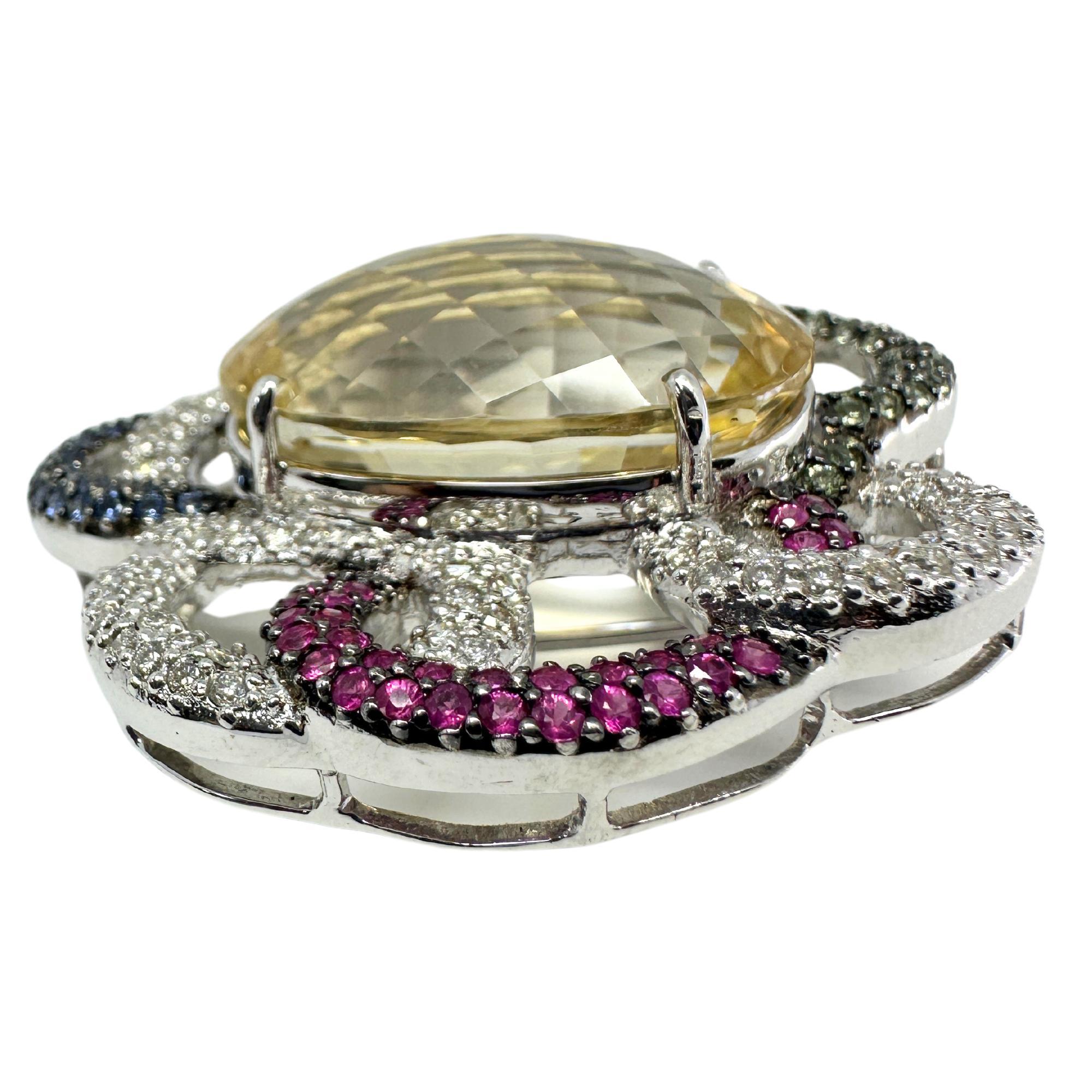 18K White Gold Citrine, Diamond and Multi Sapphire Brooch. This brooch is made up of 52.10 carats of citrine, 2.99 carats of multicolor sapphire and 1.70 carats of diamonds.

18K White Gold Citrine, Diamond and Multi Sapphire Brooch
Condition: In