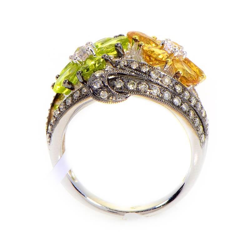 This ring is cute and colorful. It is made of 18K white gold and boasts two flower shaped motifs. The flowers are made of ~3ct of citrine, accented with ~.62ct of diamonds.
