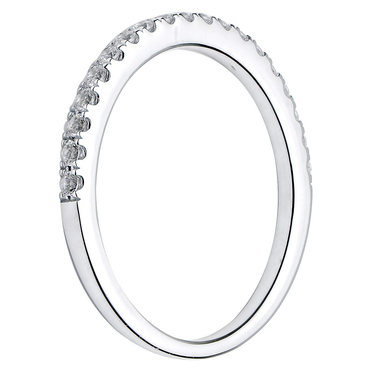 This beautiful simple and classic band has 19 round VS2, G color diamonds that are set halfway around the band. The band is made from 1.7 grams of 18 karat white gold and has lovely prong details. This ring is size 6.