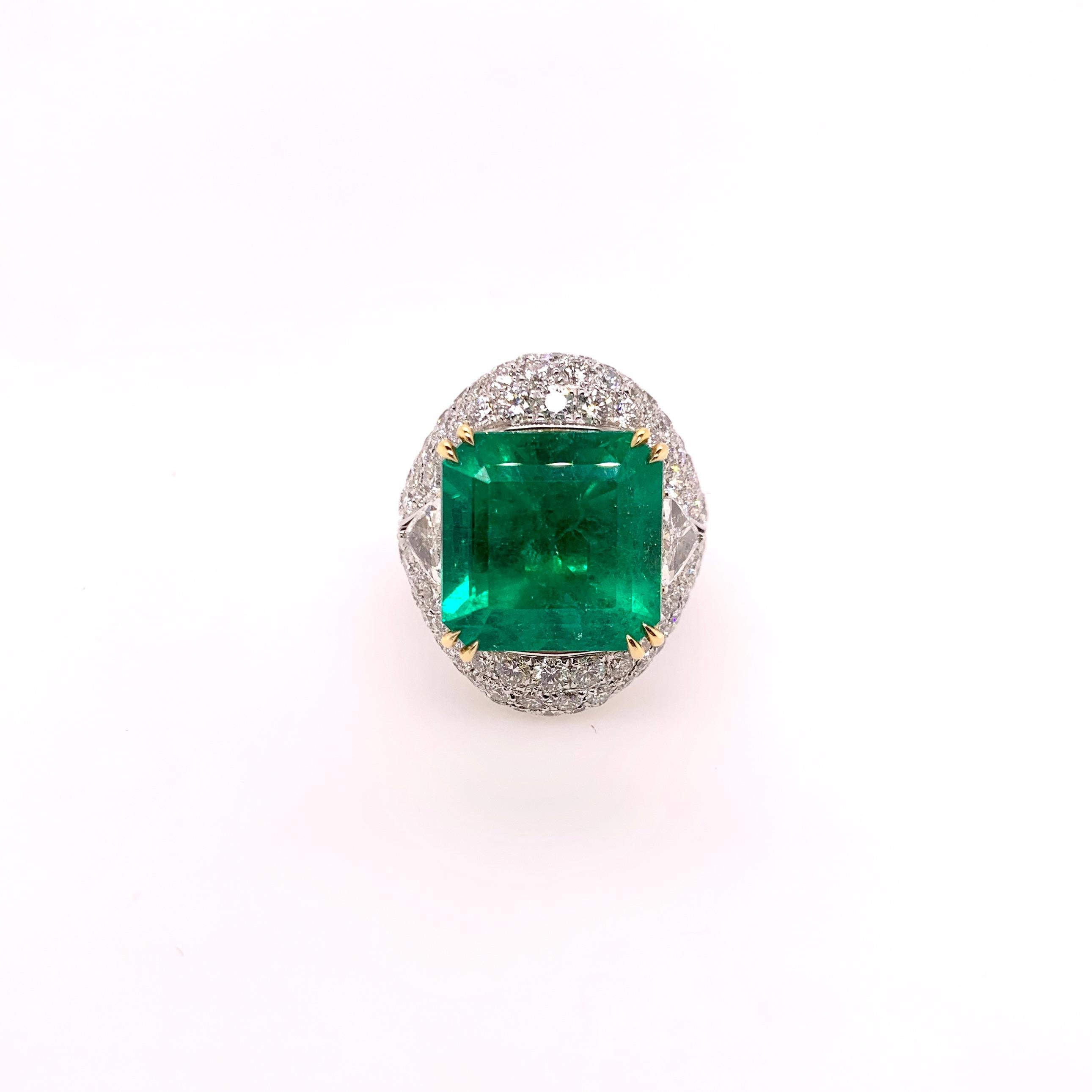 This extraordinary Colombian Emerald ring (with GRS Certificate) can be worn in a classic 3-stone style or in an elaborate diamond jacket. The Emerald is set in a custom diamond setting with trillion cut diamonds on the side and round pave diamonds