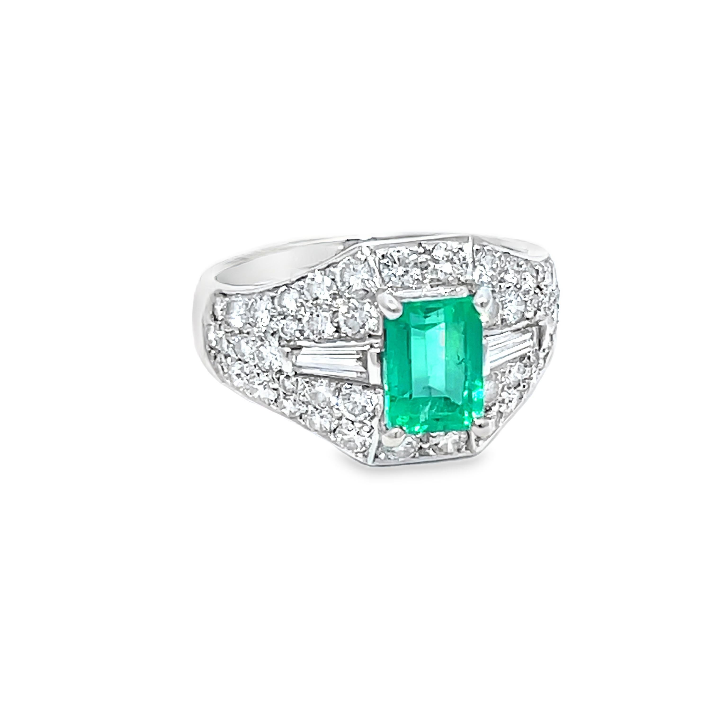 Experience the allure of this modern cluster ring, a masterpiece of contemporary design. At its heart lies a captivating 1.25-carat emerald-cut Columbian Emerald, radiating a vibrant green hue. Surrounding the centerpiece are 1.33 carats of