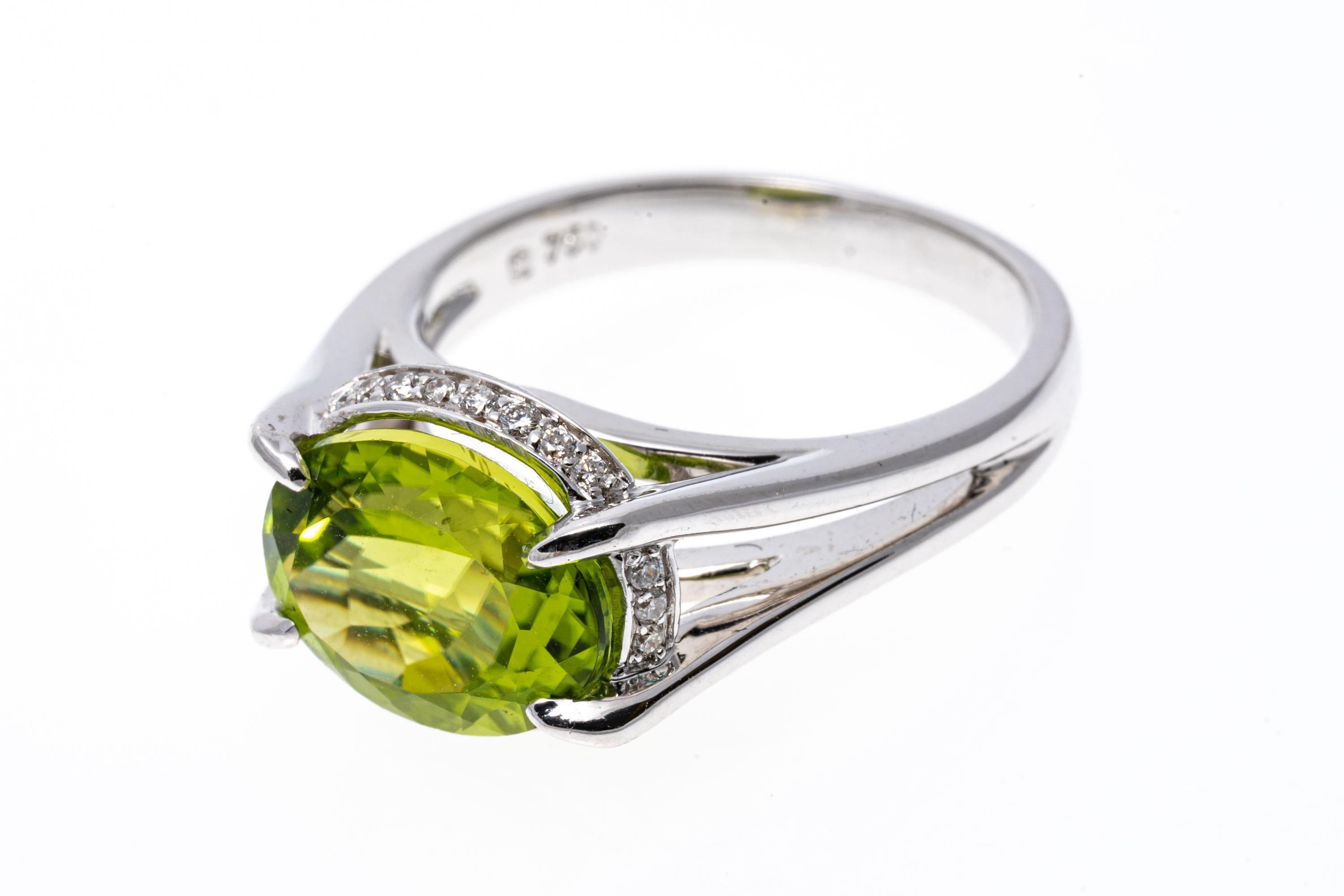 Women's 18k White Gold Contemporary Horizontal Peridot and Diamond Halo Ring For Sale