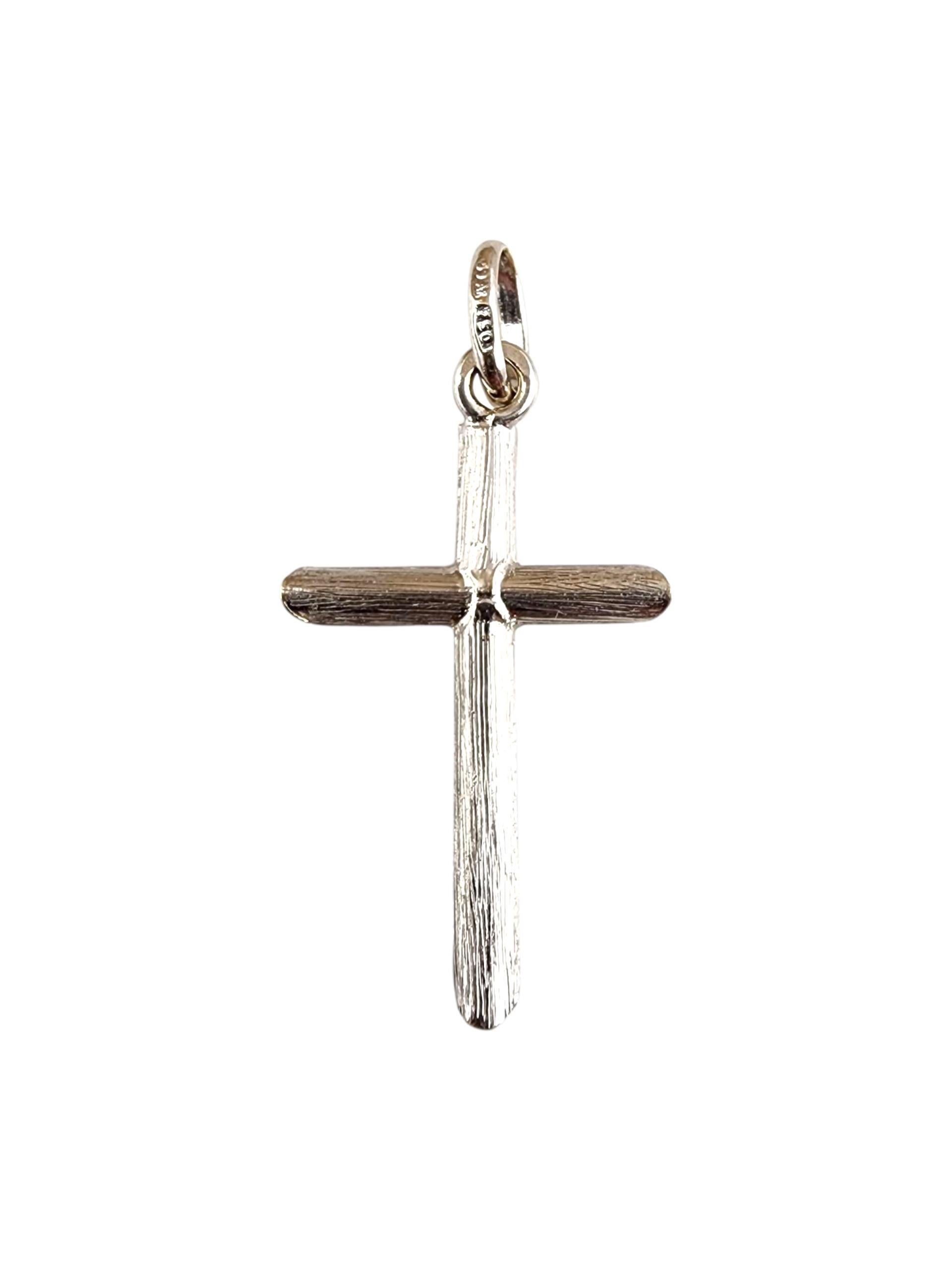 18K White Gold Cross Pendant -

This 18K white gold cross pendant offers a sleek, modern take on a timeless symbol of faith. With its clean lines and radiant polished finish, it exudes understated elegance and spiritual meaning. Perfect for everyday