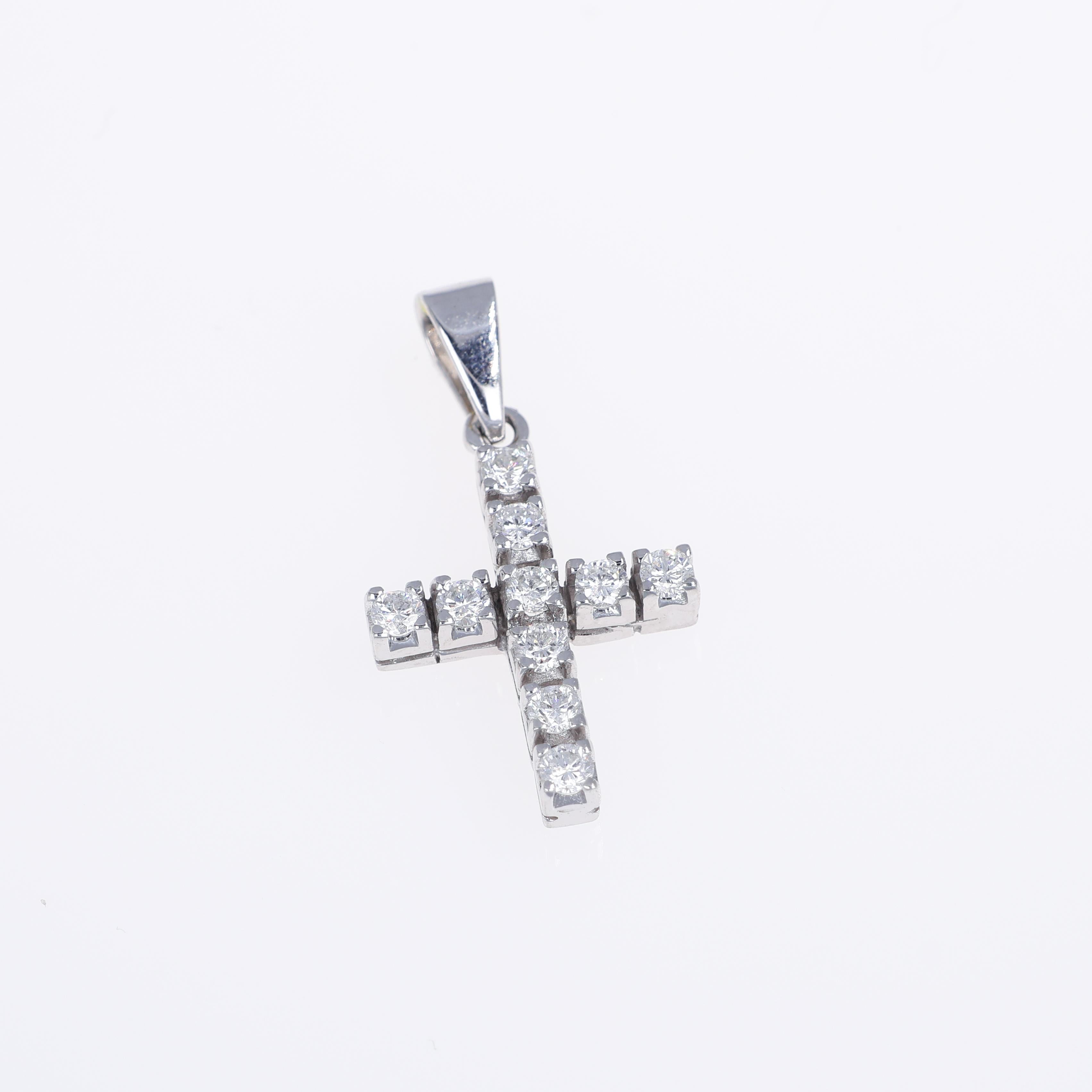 An elegant cross pendant crafted in 18K white gold, featuring a sleek design adorned with natural white diamonds. With a total diamond weight of 0.76 carats, the brilliant-cut stones offer a radiant sparkle that enhances the pendant's timeless