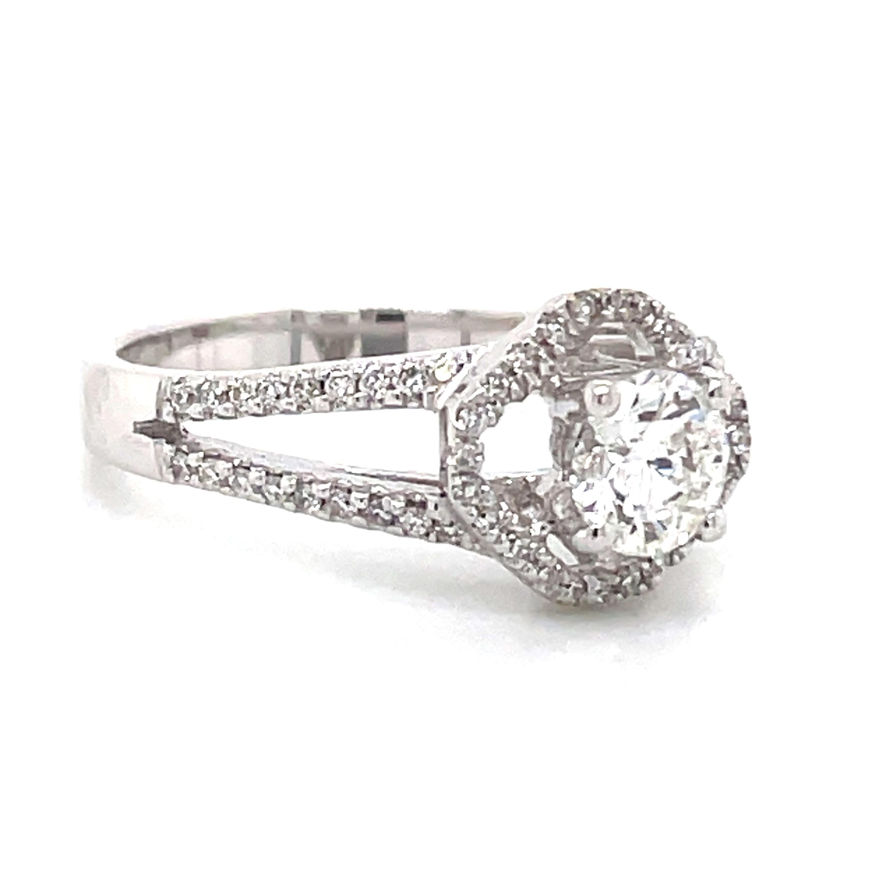 Elegance meets brilliance in this stunning 18k White Gold Round Brilliant Halo Diamond Engagement Ring. 

The centerpiece is a dazzling GIA-certified diamond round at 0.54 cts that is held securely in a four-prong setting, showcasing exquisite