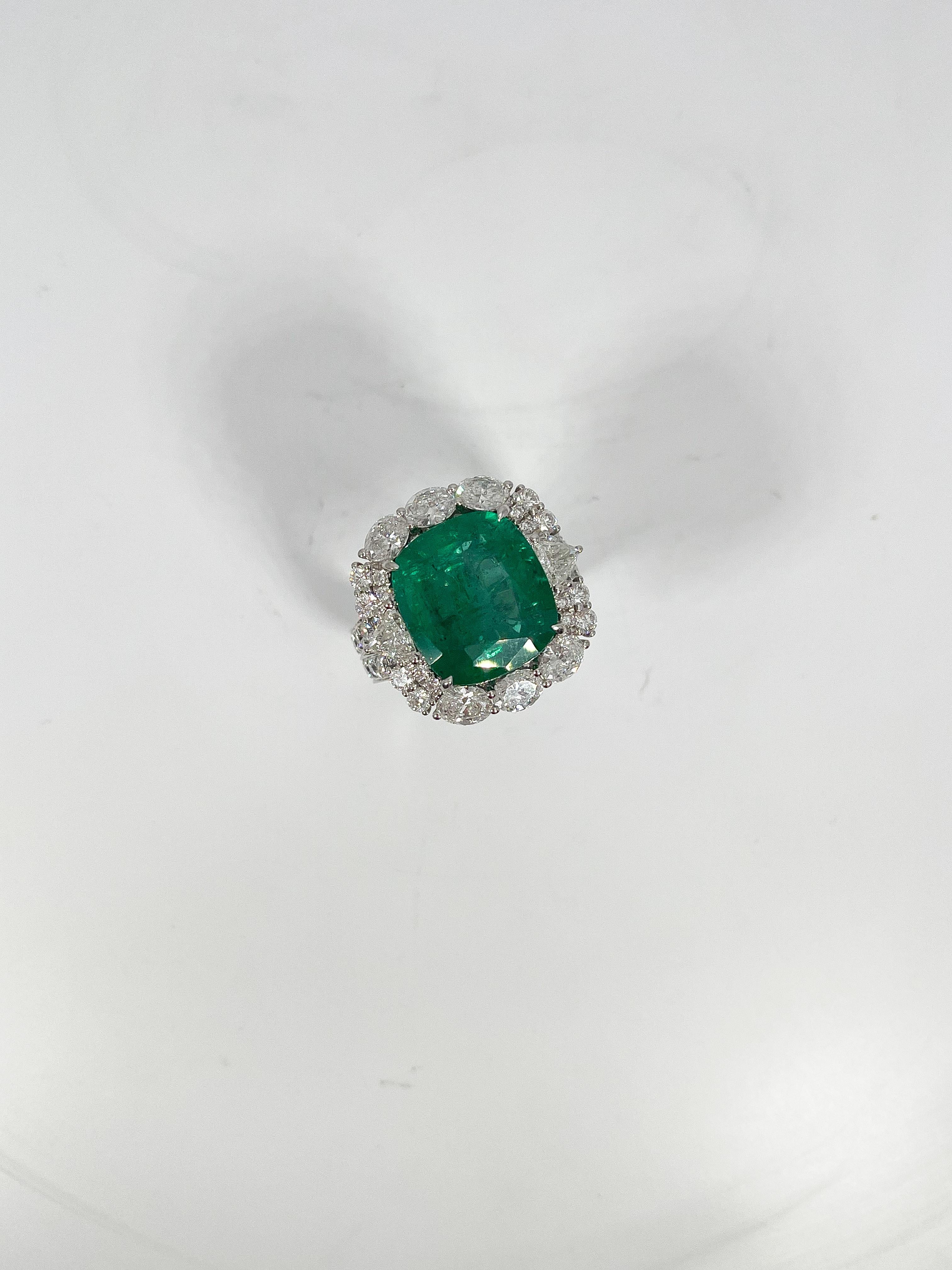 Ladies 18k white gold size 7 ring, prong set with a cushion brilliant cut emerald and multi-shaped diamonds. Total item weight is 16.4 Grams. Comes with AJI Certification.
Emerald Attributes: 
Shape and cut- Cushion brilliant cut
Measurements-