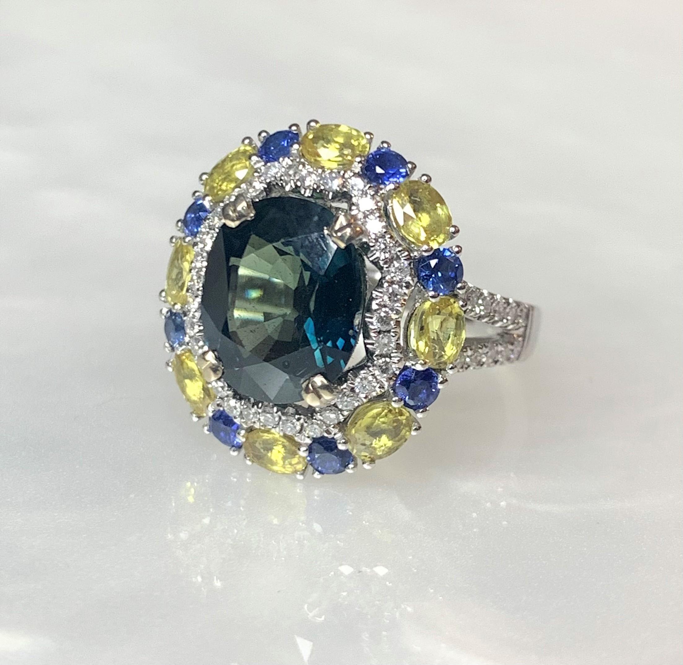An outstanding and luxurious blue sapphire ring with a cushion cut center stone weighing 4.94 carats surrounded by a scalloped edge halo of sparkling white diamonds weighing 0.43 carats hugged by contrasting alternating yellow sapphires weighing