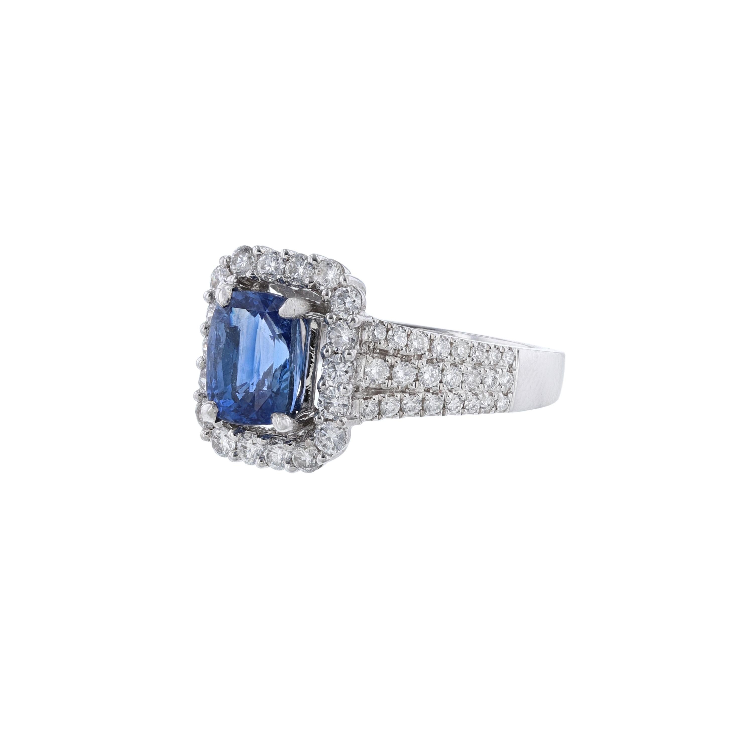 This ring is made in 18K white gold and features 1 cushion cut blue sapphire weighing 2.44 carats. Also, the ring features 64 round cut diamonds weighing 0.91 carat. With a color grade (H) and clarity grade (SI1).
