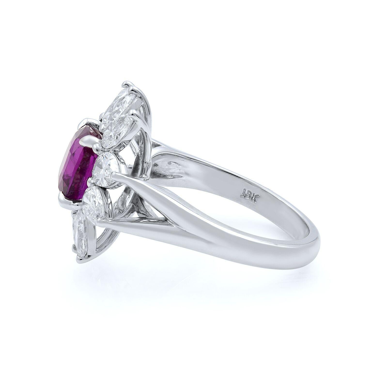 This unique ruby flower shaped ring with diamonds is crafted in 18K white gold. Ruby cushion stone weights 2.56cts and pear shaped diamonds are weighting 1.90cts. Ring Size 7. 