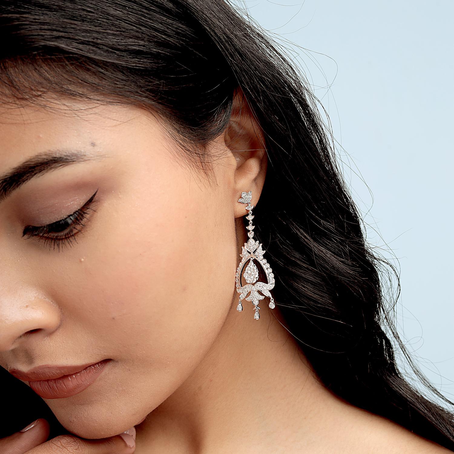 These ornate chandelier earrings combine radiant artistry and luxury, featuring 2.80 carats of sparkling diamonds set in 18-karat white gold. With a dramatic 62x20mm length, they make the perfect statement for elegant occasions or upscale