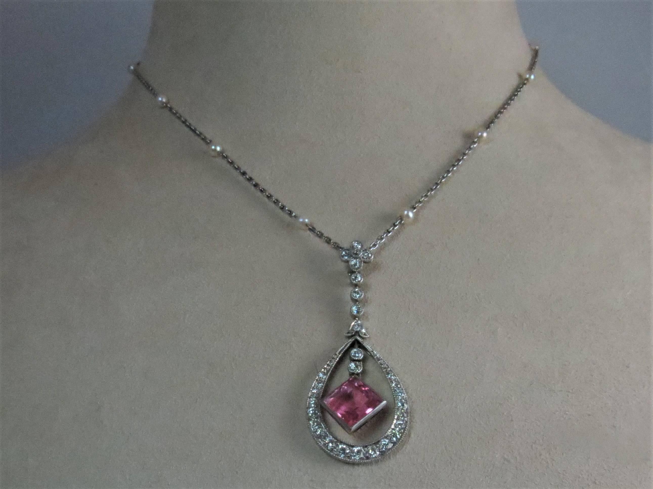 18K white gold pear shape pendant, bead set with 30 old  European cut diamonds weighing approximately 1ct, H-I color, VS-SI clarity and one bezel set square pink tourmaline weighing approximately 3cts suspended from 16 inch white gold chain with