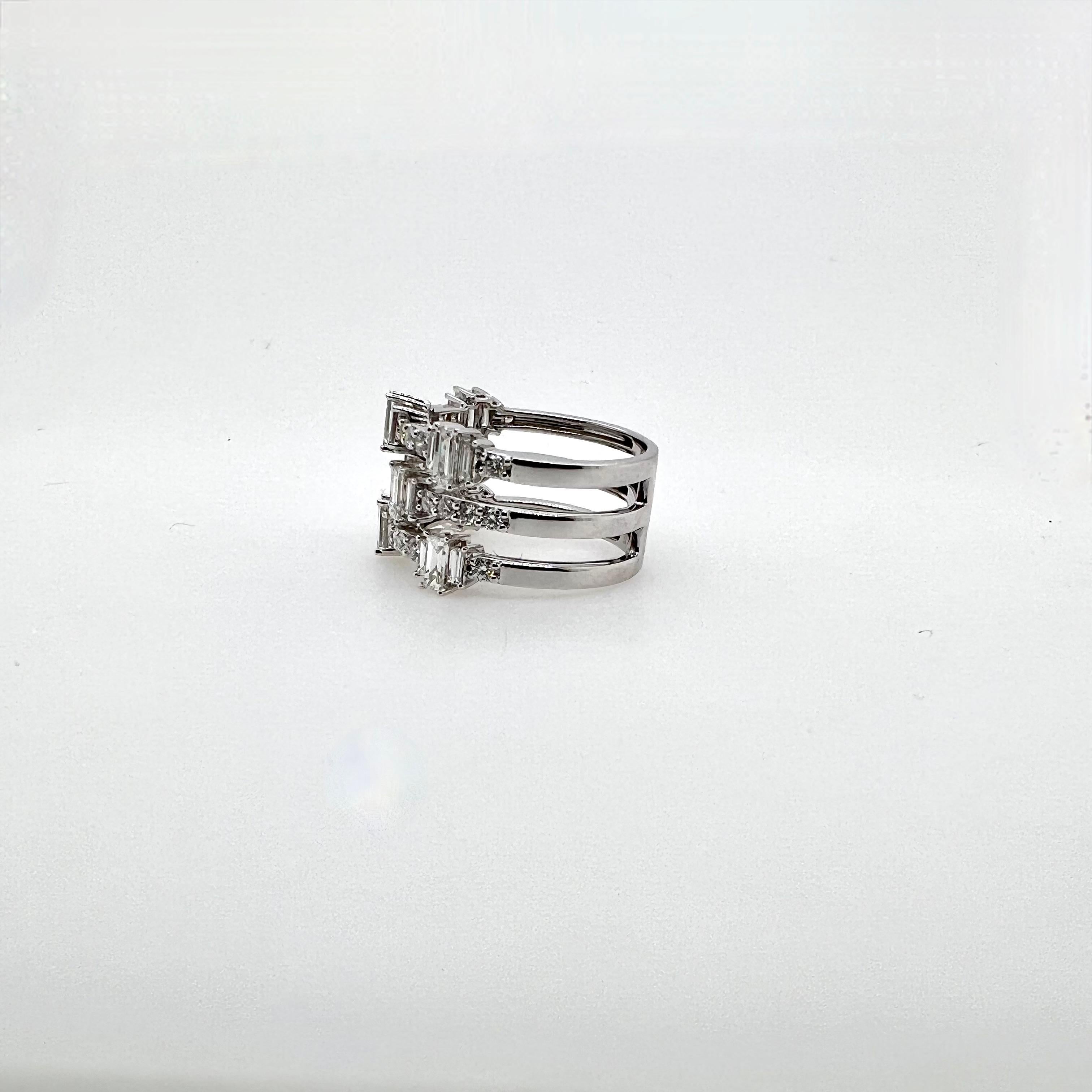 This stunning 3 row diamond band is an eye catcher!  The 18k white gold band is made up with round brilliants, emerald cuts, and baguettes diamonds with a modern look.  A versatile ring that can be worn casually or business casual!  

Diamonds: 