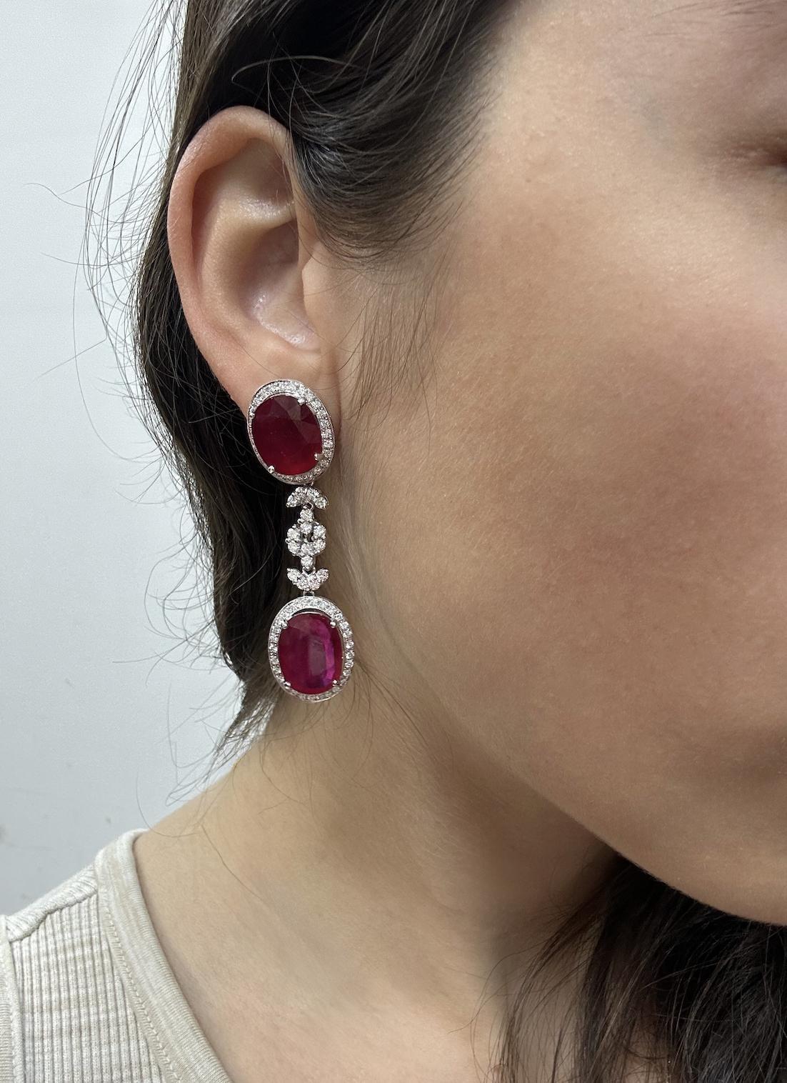 18K White Gold Diamond and African Ruby Drop Earrings
18K white gold drop earrings. 16.1 grams, 2.15 inches long. Set with 23.49 carats of oval African ruby and 2.16 carats of diamonds. Marked “750” and “T897”. In good condition with minor surface