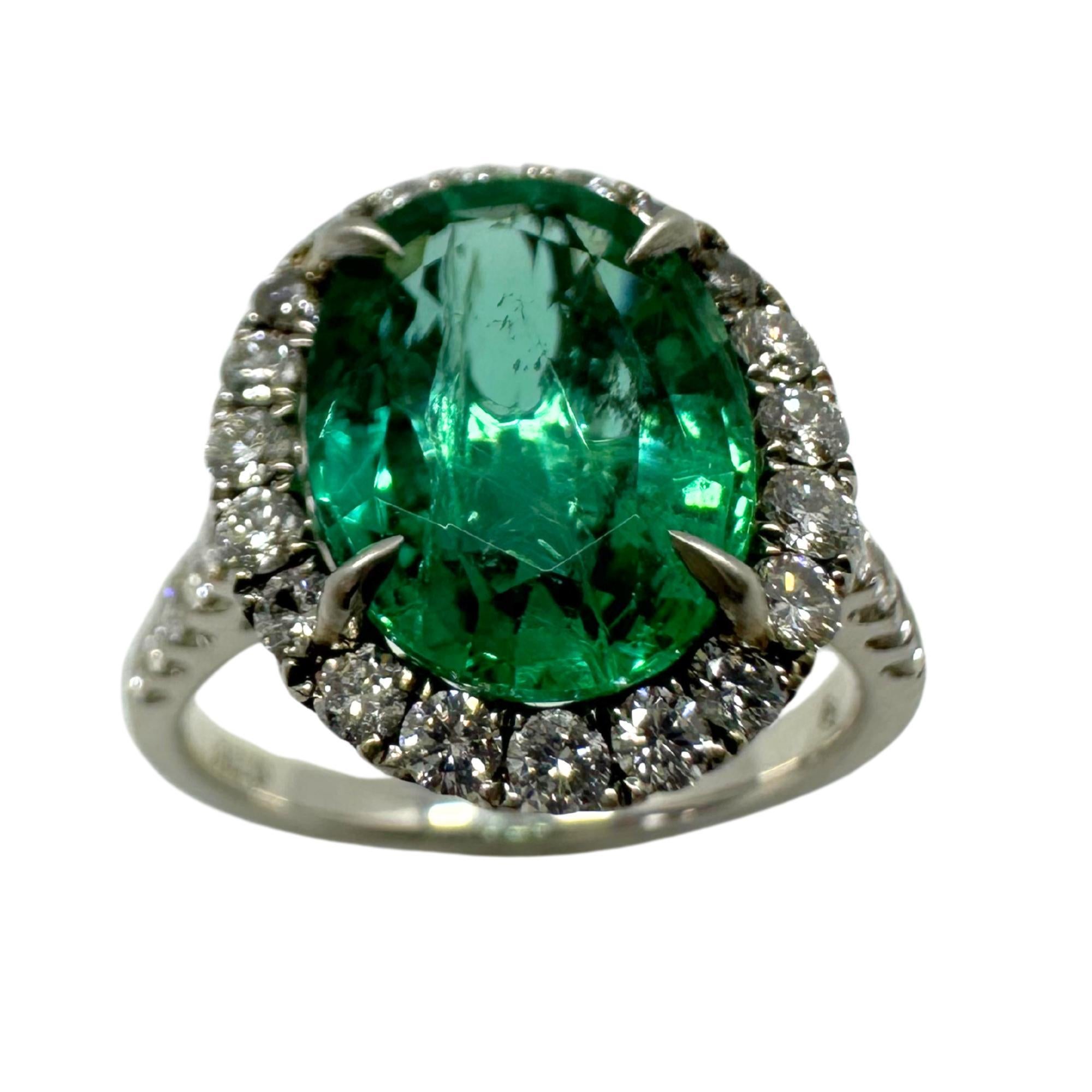 Add a touch of elegance to your jewelry collection with our 18k White Gold Diamond and Emerald Ring. Weighing 4.70 grams and with a size of 7, this stunning ring features a 3.63 carat round emerald at its center, surrounded by a sparkling diamond