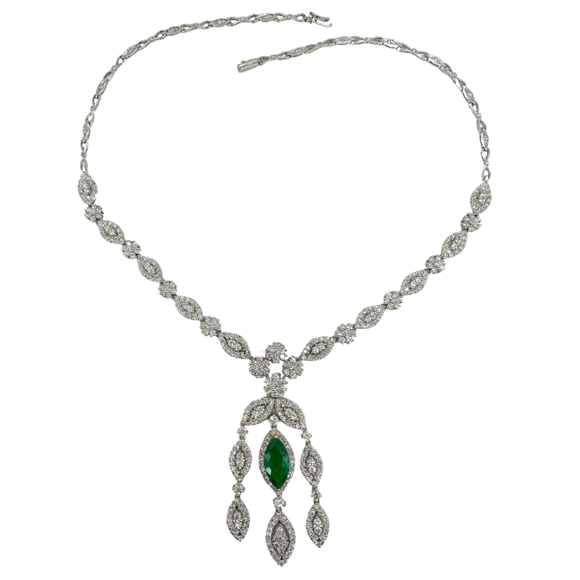 18K White Gold Marquise Emerald and Diamond Drop Necklace. 30.2 grams, 15 inches long with a 2-inch drop. Showcases a vivid 2.05-carat marquise-cut emerald accented by 7.36 carats of sparkling diamonds in a floral and navette motif, finished with an