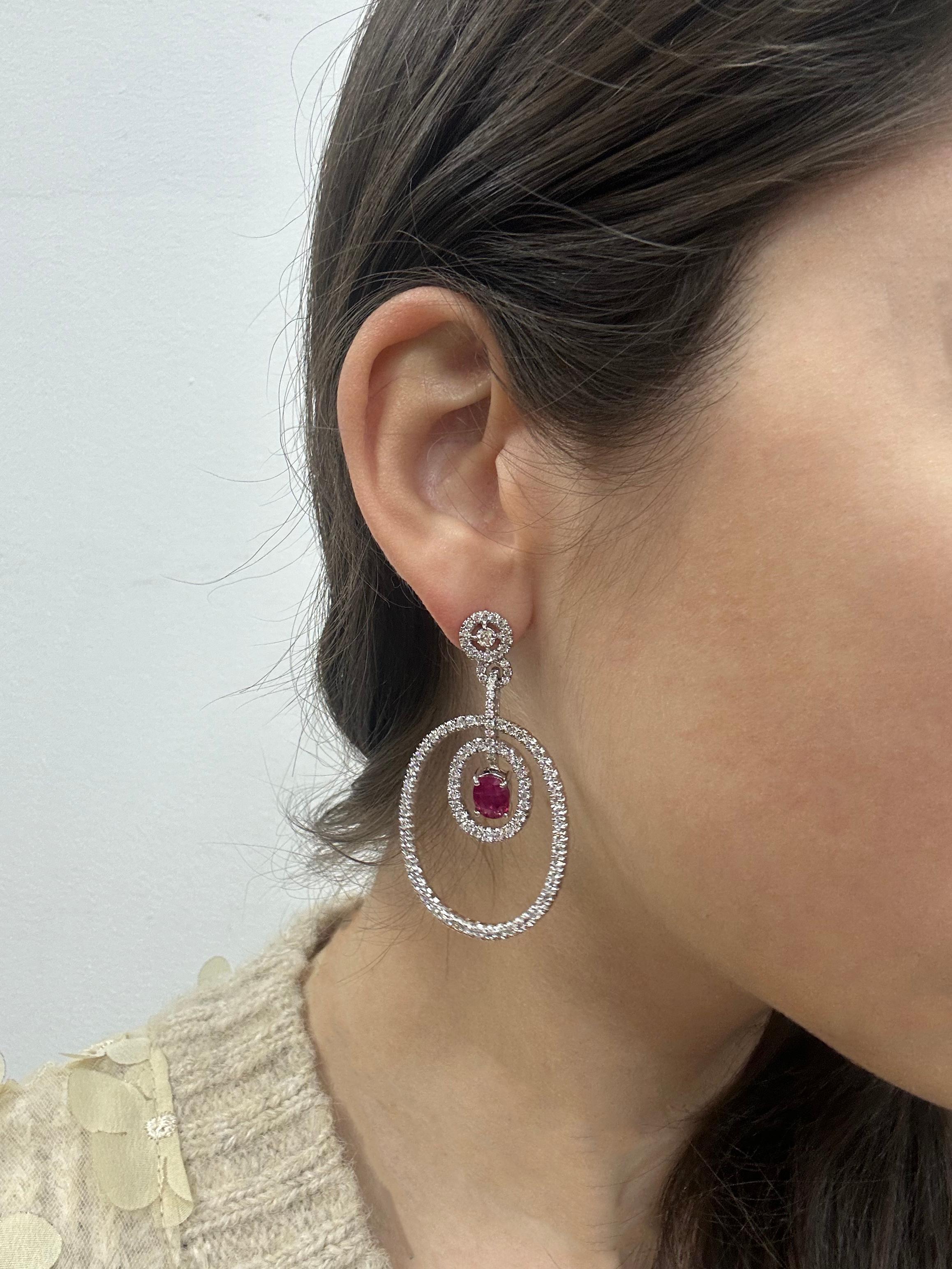 18K White Gold Diamond and Oval Ruby Drop Earrings
Condition: In good condition with some minor surface wear consistent with age. 
Length: 2 inches 
Width: 1.25 inches
Metal: 18K White Gold 
Weight: 16.9 grams 
Diamonds: 3.66 carats 
Ruby: 2.46