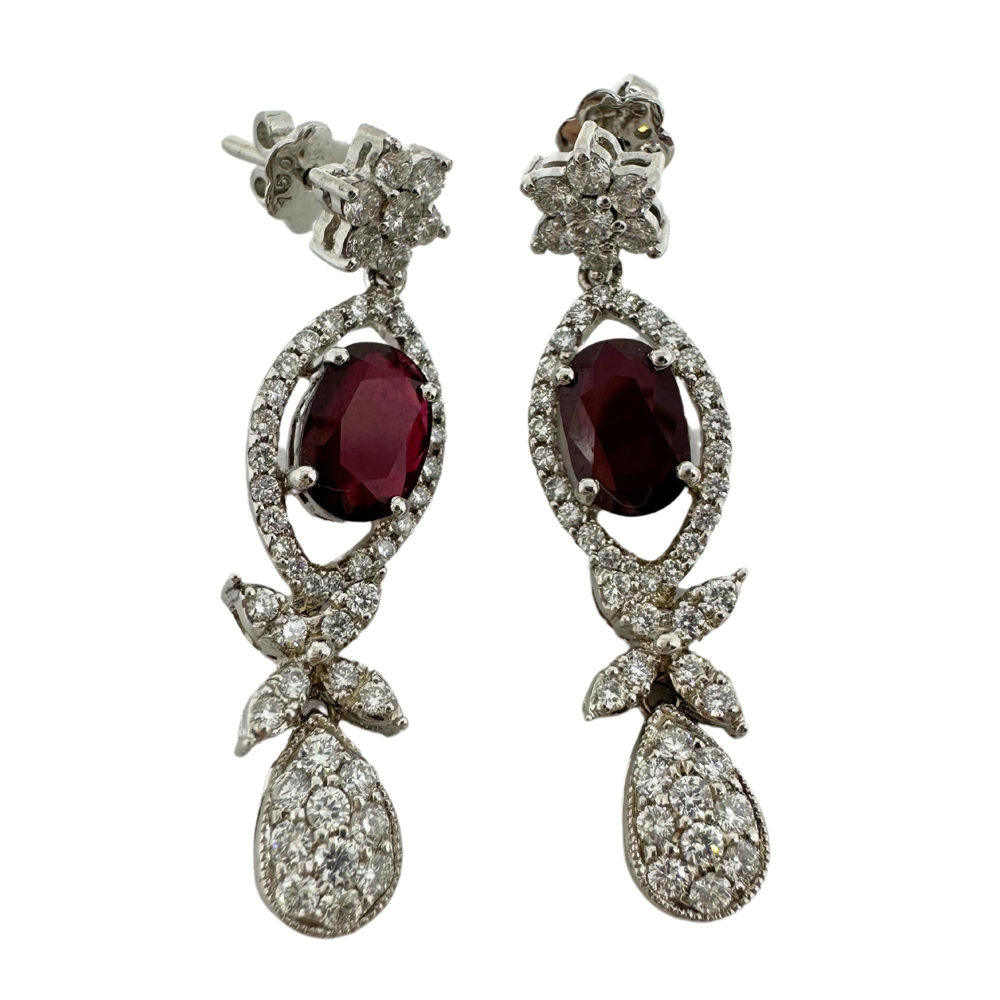 18k White Gold Diamond and Oval Ruby Earrings
Condition: In good condition with some minor surface wear consistent with age.
Length: 1.5 inches
Metal: 18k White Gold
Weight: 6.58 grams
Diamonds: 1.40 carats 
Ruby: 2.19 carats