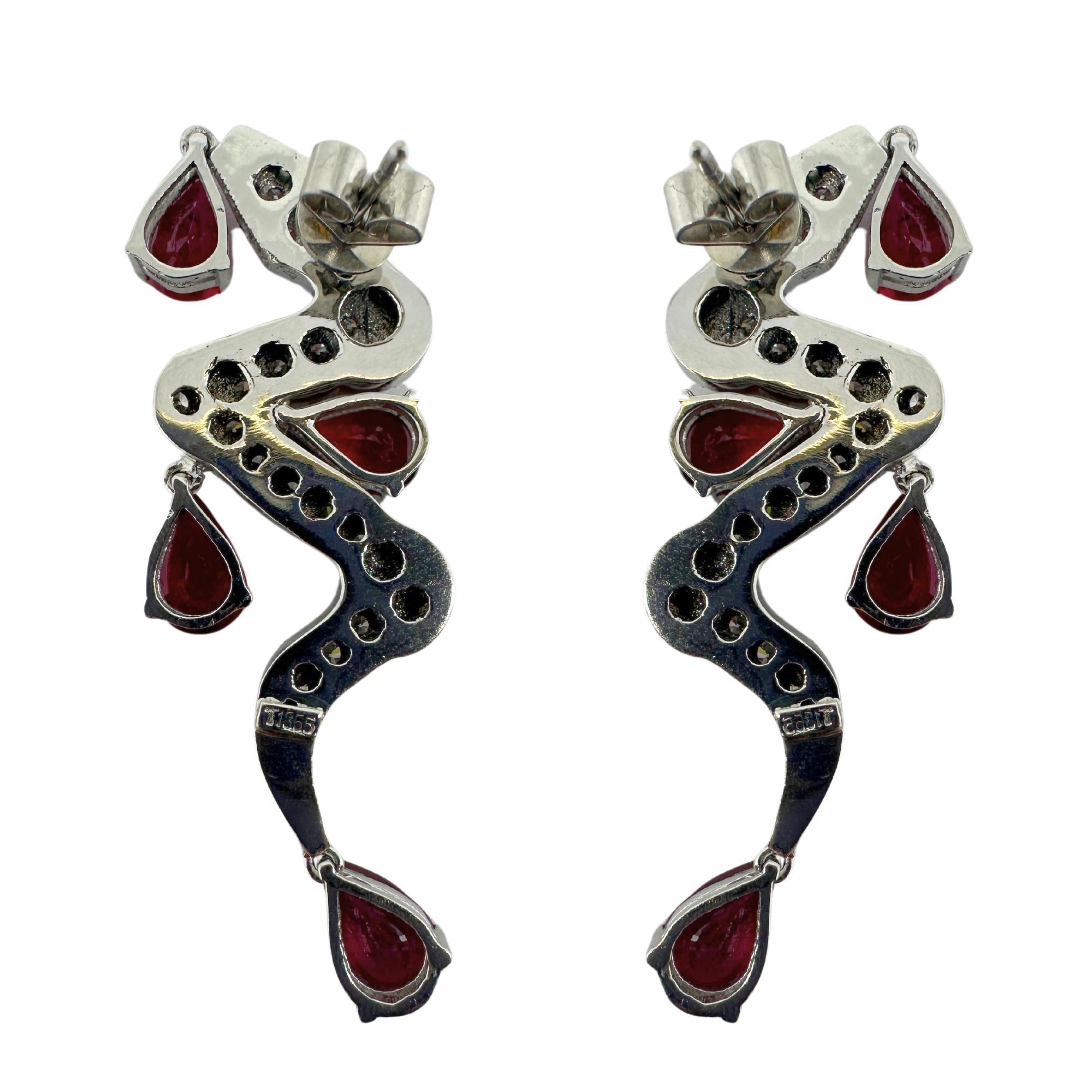 Add a touch of elegance to your outfit with these 18K white gold earrings featuring 2.58 carats of sparkling diamonds and 8.00 carats of rich rubies. At 2 inches in length and a weight of 17.22 grams, they are the perfect statement piece for any