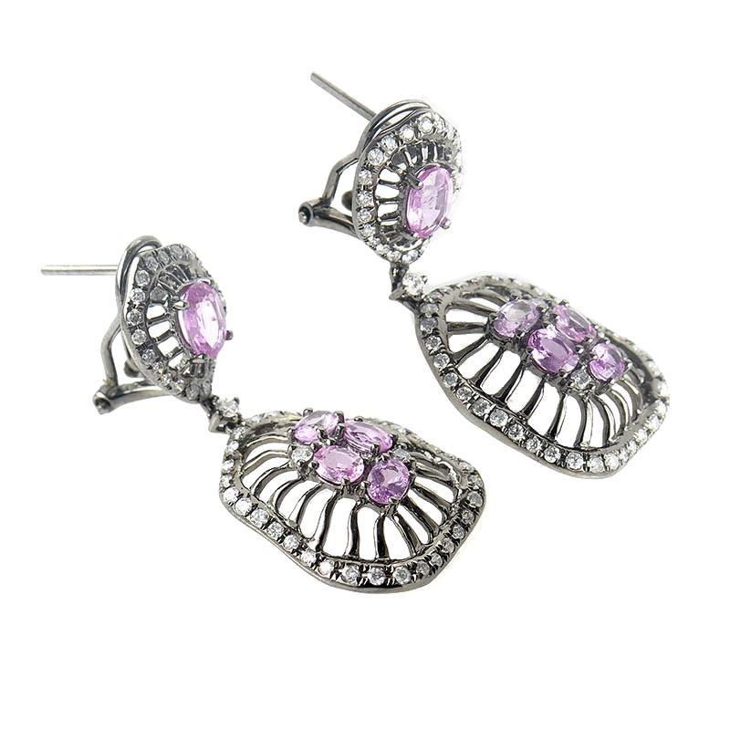 This pair of drop earrings are colorful and unique. They are made of black rhodium dipped 18K white gold and boast a design that features ~2.59ct of pink sapphires and ~1.09ct of diamonds.