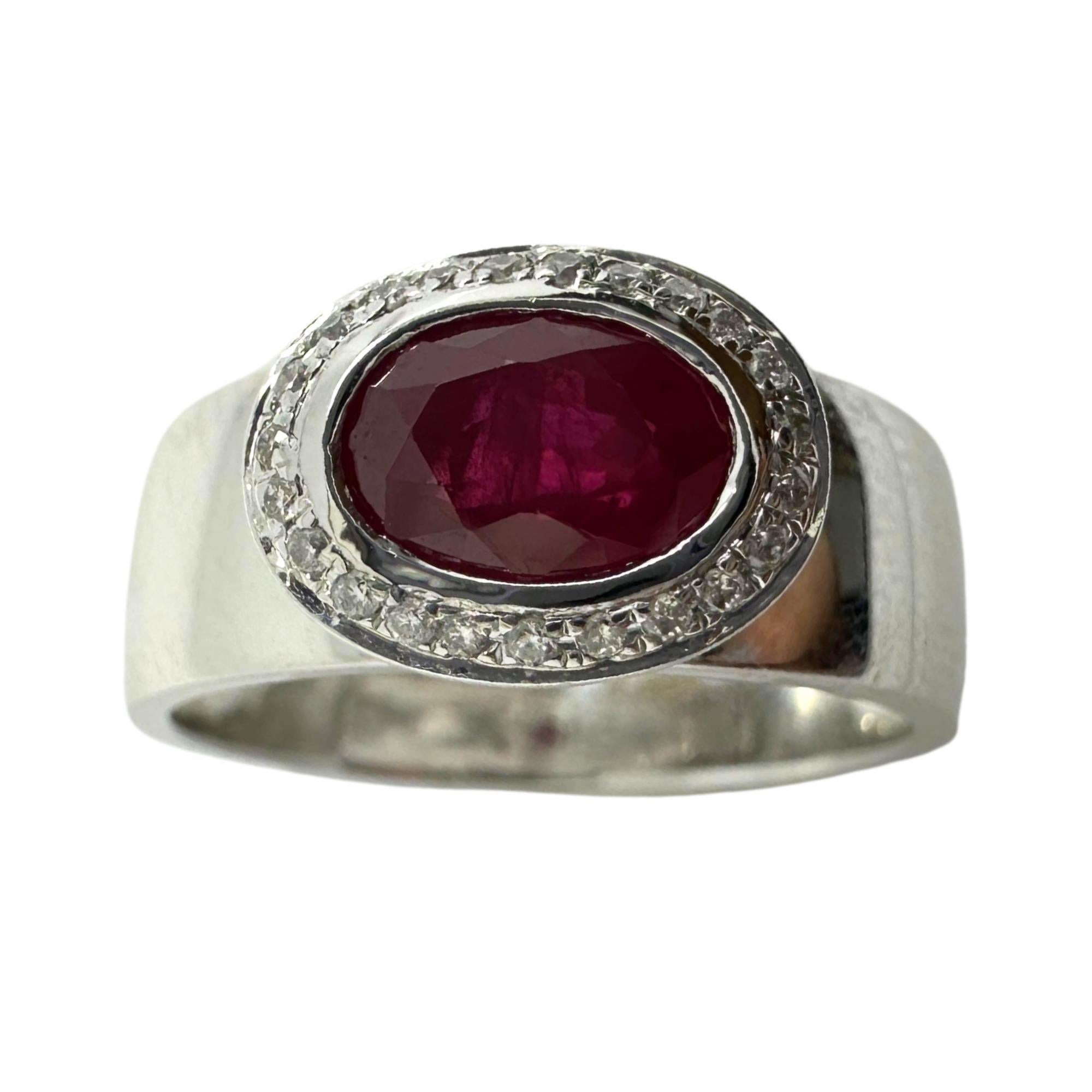 This stunning band is set in 18k white gold setting and weighs 5.8 grams. There is a beautiful 1.14 carat ruby in the center surrounded by 0.07 carats of diamonds.

18K White Gold Diamond and Ruby Band Ring
Condition: In good condition with some