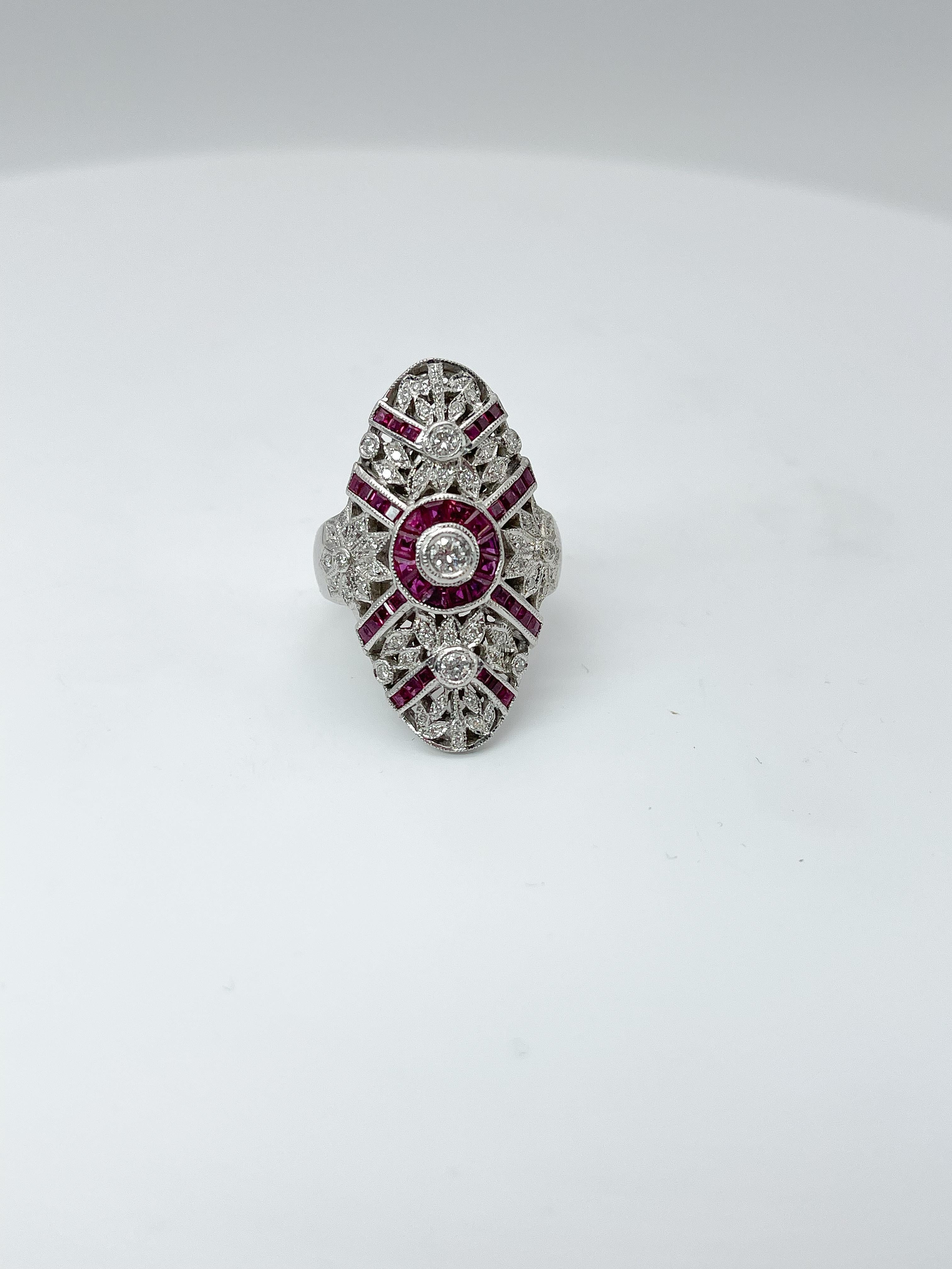 This vintage 18k white gold cocktail fashion ring has a beautiful filigree design with 34 princess cut rubies, 6 trillion rubies, and 57 round diamonds. Ring measures a size 8 and weighs 13.27 grams. 