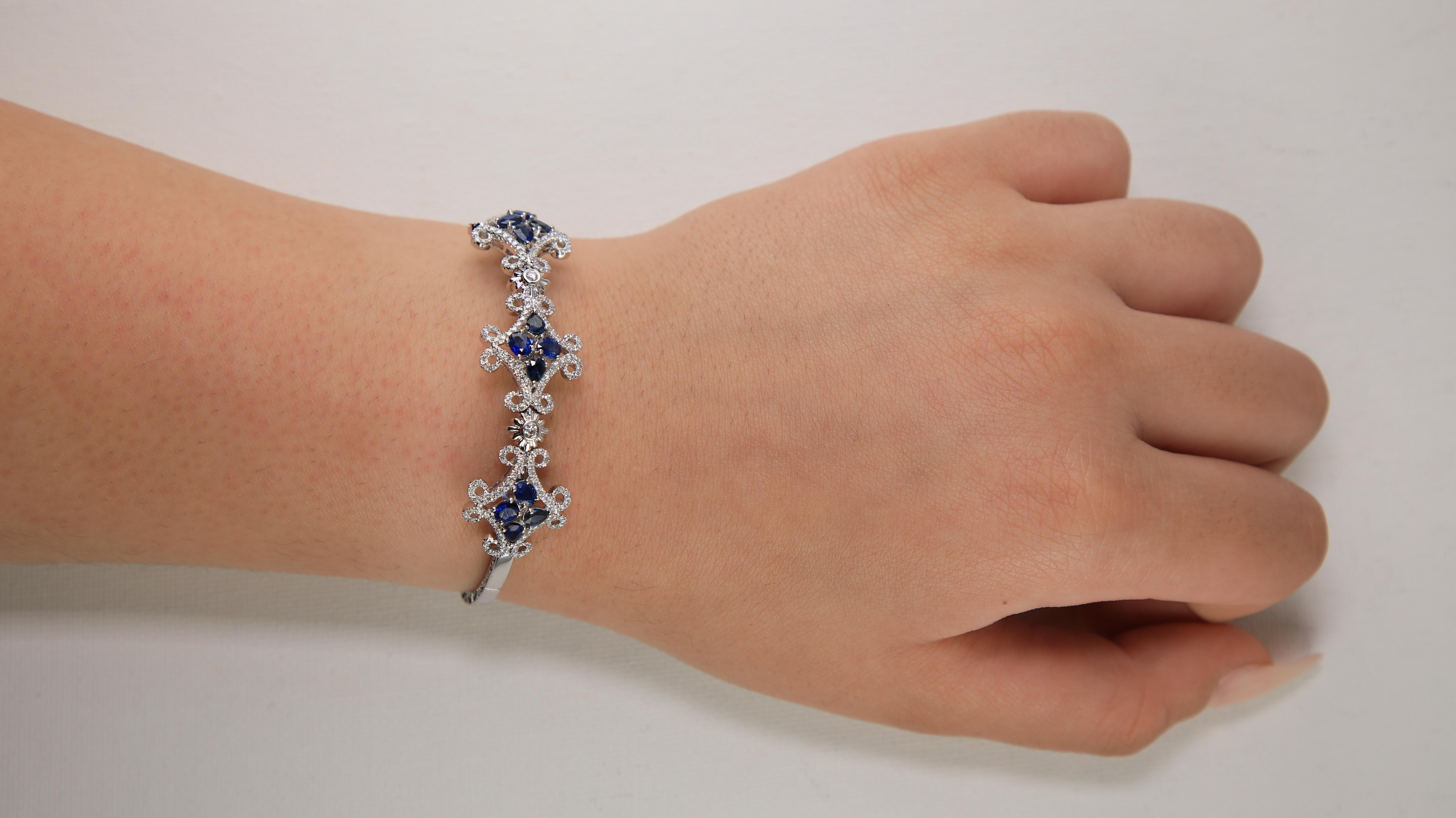 18 Karat White Gold Diamond and Sapphire Cuff Bangle Bracelet
Timeless detail and design! A well decorated Sapphire cuff bracelet with a flexible18k white gold structure. Set within the fine motifs are oval and pear shape sapphires, totaling to 2.31