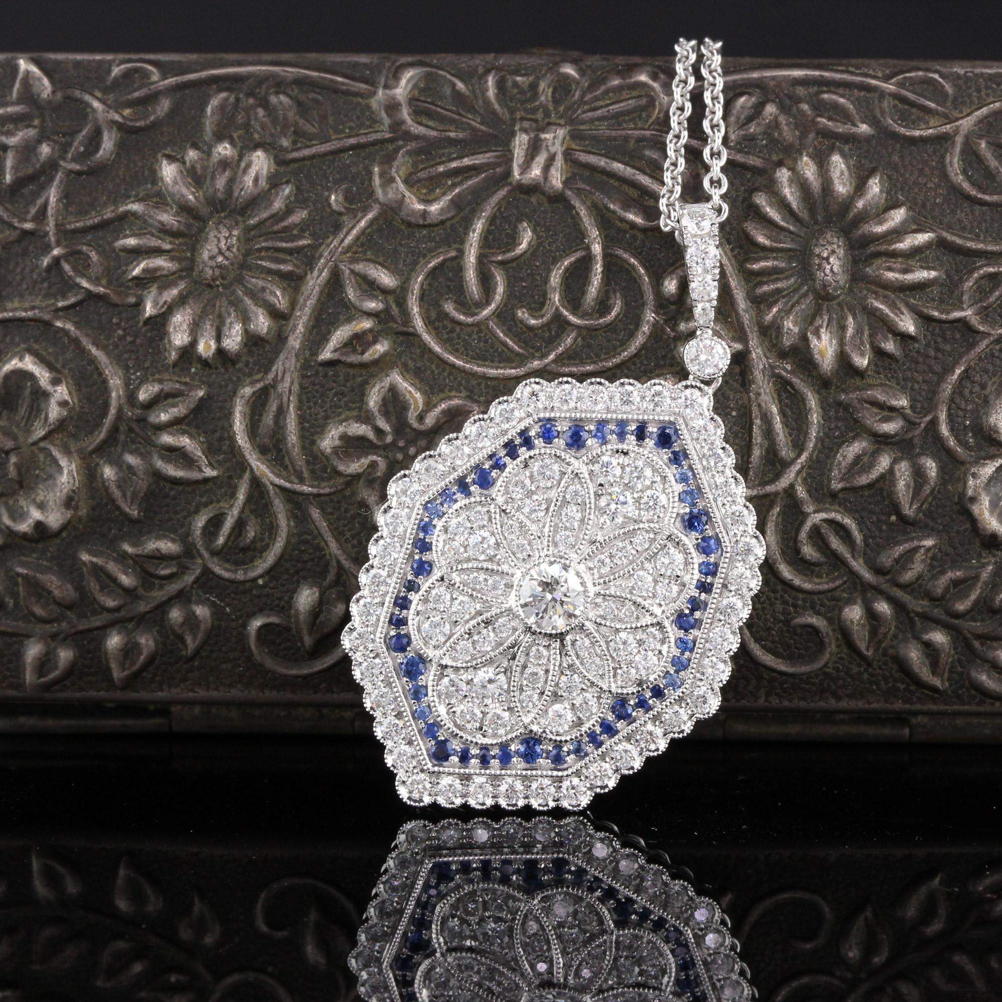 Gorgeous sapphire and diamond pendant with dazzling diamond center.

Metal: 18K White Gold

Weight: 8.1 Grams

Diamond Weight: Approximately 1.20 ct.

Diamond Color: G

Diamond Clarity: VS2

Gemstone Weight: Approximately 0.50 ct.