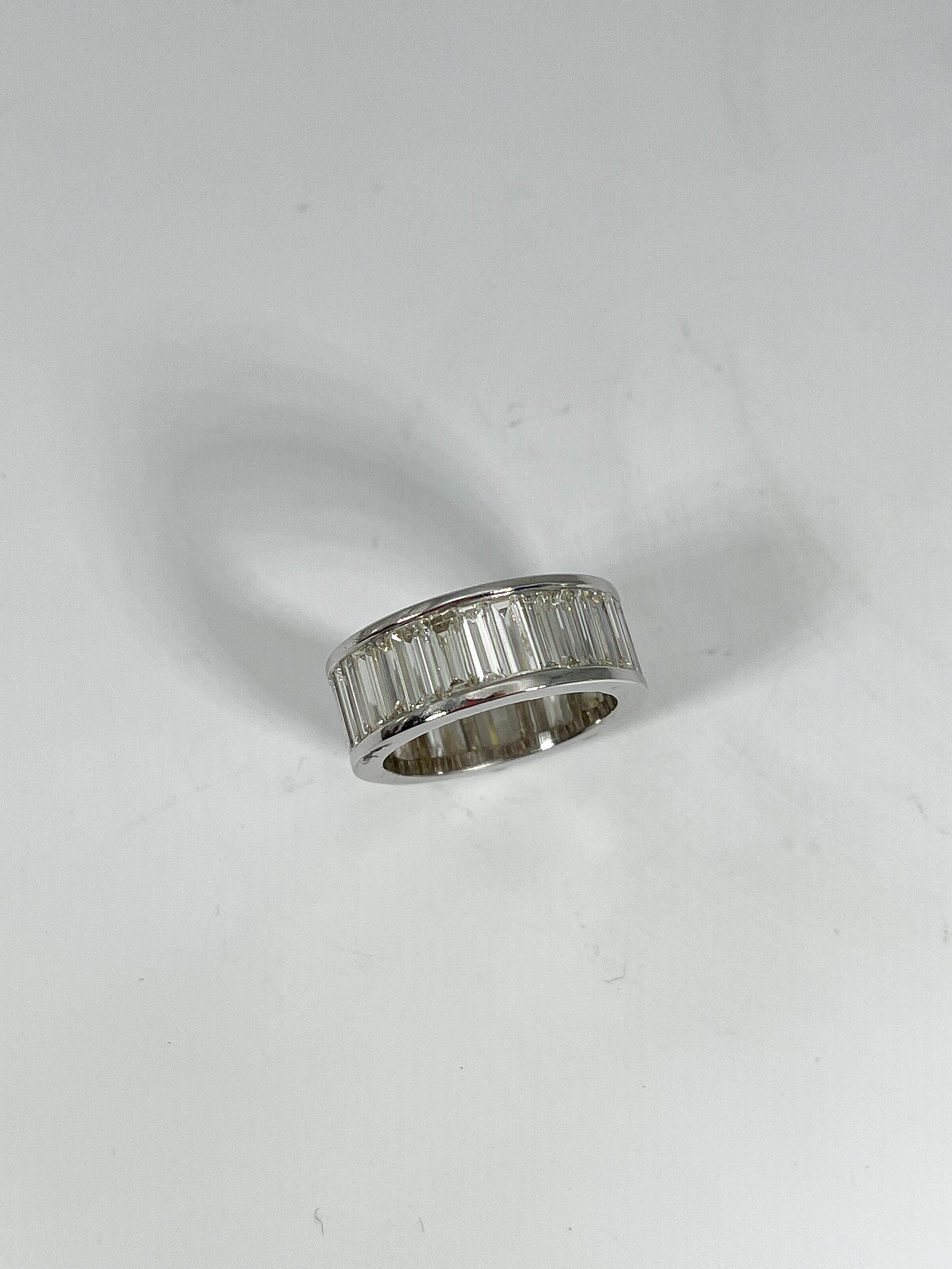 18k white gold eternity band, each stone is an emerald cut diamond equaling a total CTW of 8. All diamonds are VS2 G color. Ring is a size 6, the width measures 7.8 mm, and has a total weight of 6.95 grams. 