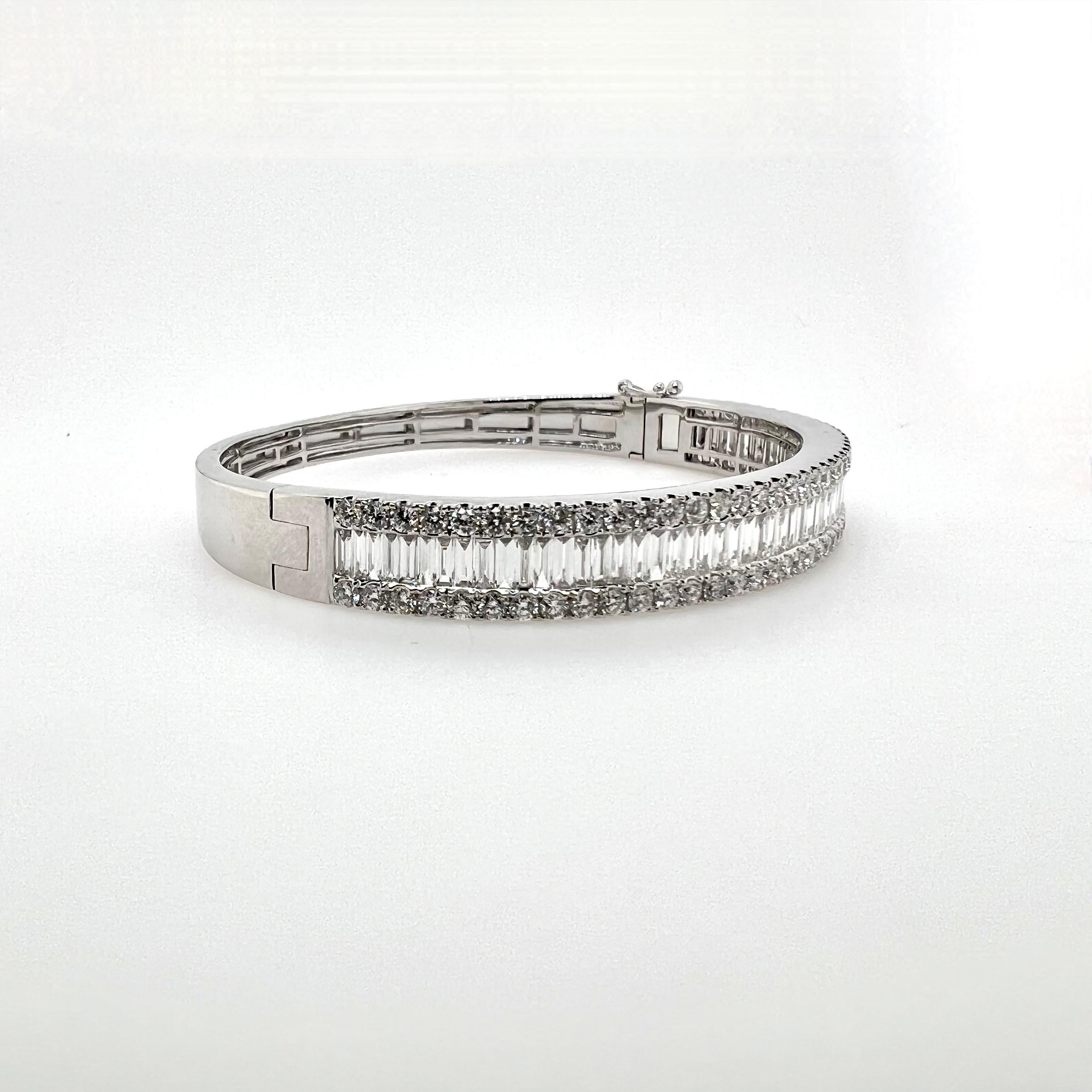 This gorgeous 18k white gold diamond bangle has beautiful baguette diamonds channeled set while the shoulders have round brilliant diamonds prong set.  At a little over 1/4'' in width, the bangle can be stacked with other items or can be worn solo