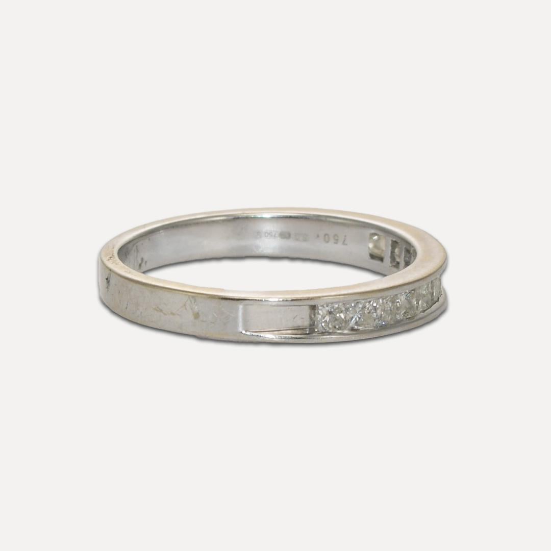 Diamond band in 18k white gold.
Stamped .750 and weighs 3.5 grams.
There are 12 princess cut Diamonds, .50 total carats, I color, SI to I1 clarity, and very good cuts.
The ring size is 8 1/4 and can be sized.
Very good condition.