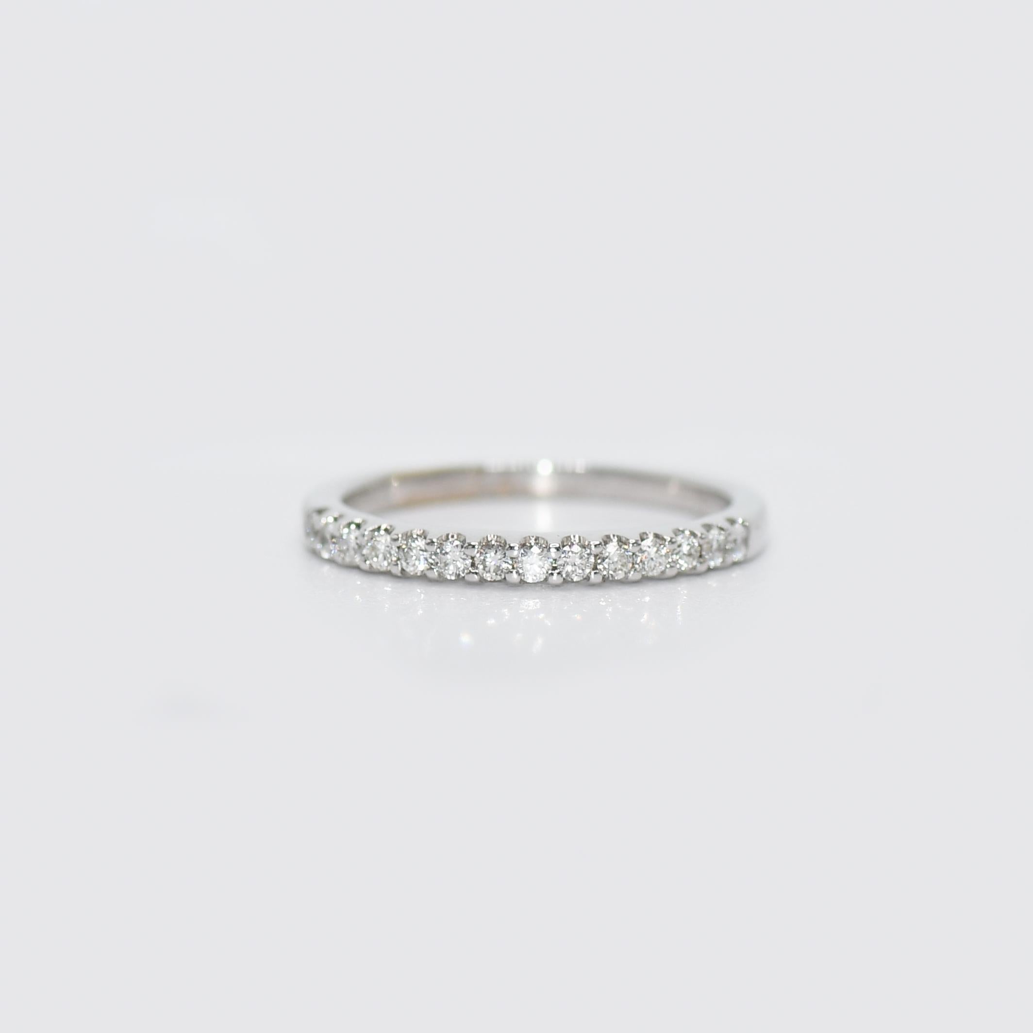 18k White Gold Diamond Band.
There is .14tdw, Round Brilliant Cuts. 
Clarity VS, Color F-G.
Stamped 750, weighs 1.9gr
Size 4 3/4, recently Rhodium Plated and Polished like new.