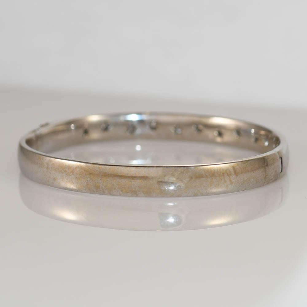 18k white gold Diamond Bangle
Stamped 18k and weighs 44 grams
There are eleven round brilliant diamonds, .33 total carats, G to H color, VS to Si clarity.
Hinge with a latch on the side.
Fits up to 6 1/2 inch wrist comfortably.
Measures 7.30mm