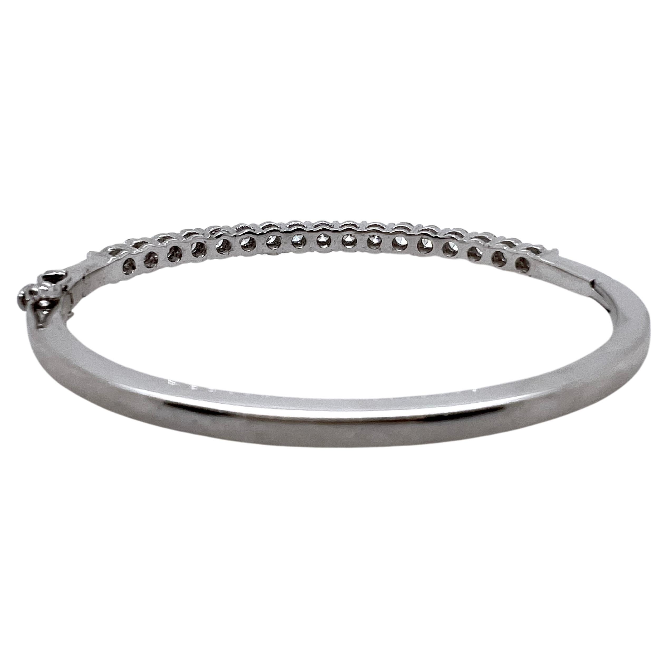 This classic diamonds bangle is set in 18k white gold with approximately 20 pointer round brilliant diamonds.  They are shared prong set, and creates a visual line of diamonds.  It can be worn dressed up or casually, so it is versatile.  Great to