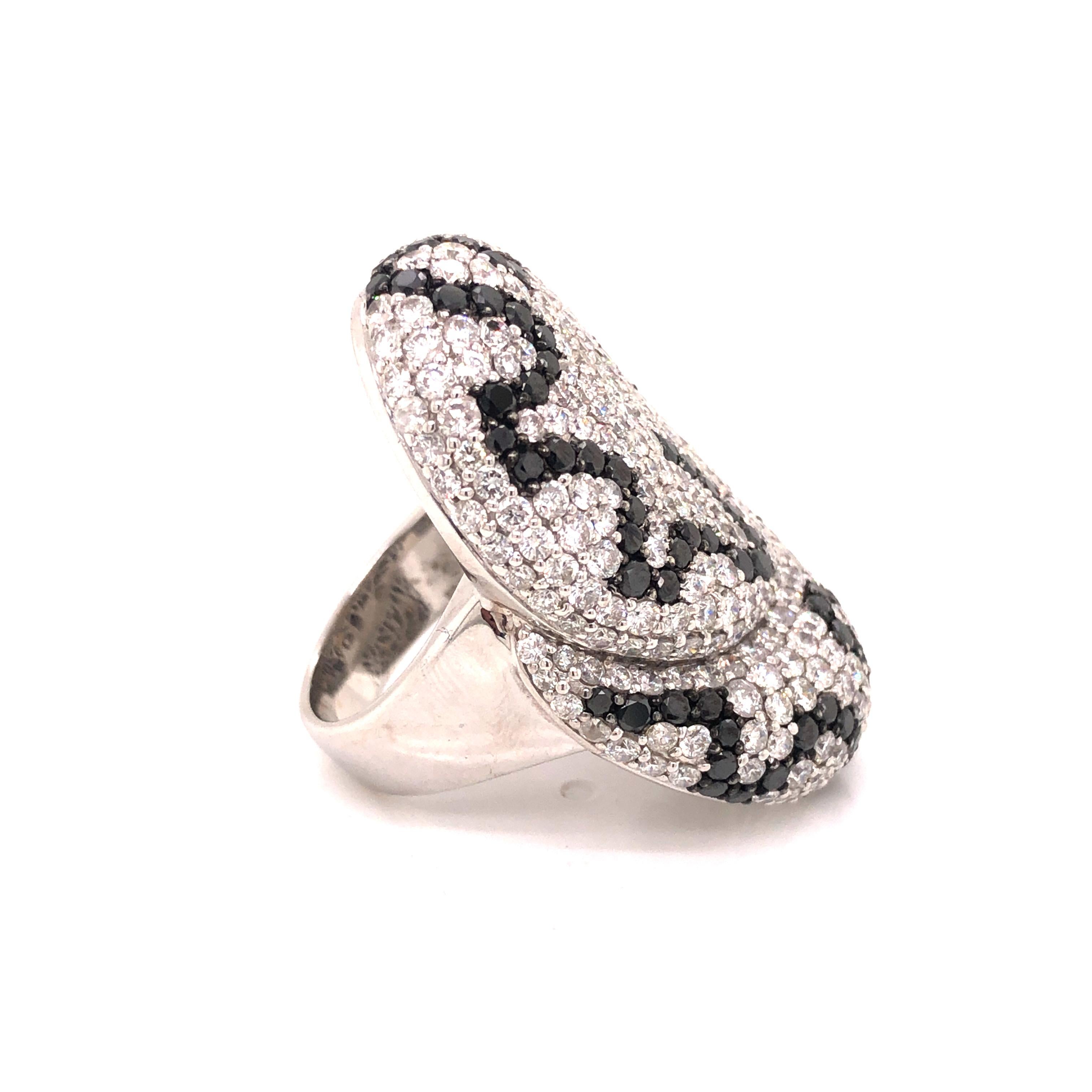 An 18K White Gold Diamond & Black Diamond Statement Ring consisting of round-cut white and black diamonds.

Stone: Diamond ~ 5.50 carats , Black Diamond ~ 2.51 carats

Metal: 18K White Gold

Size: 7

Total Weight: 20.7 grams