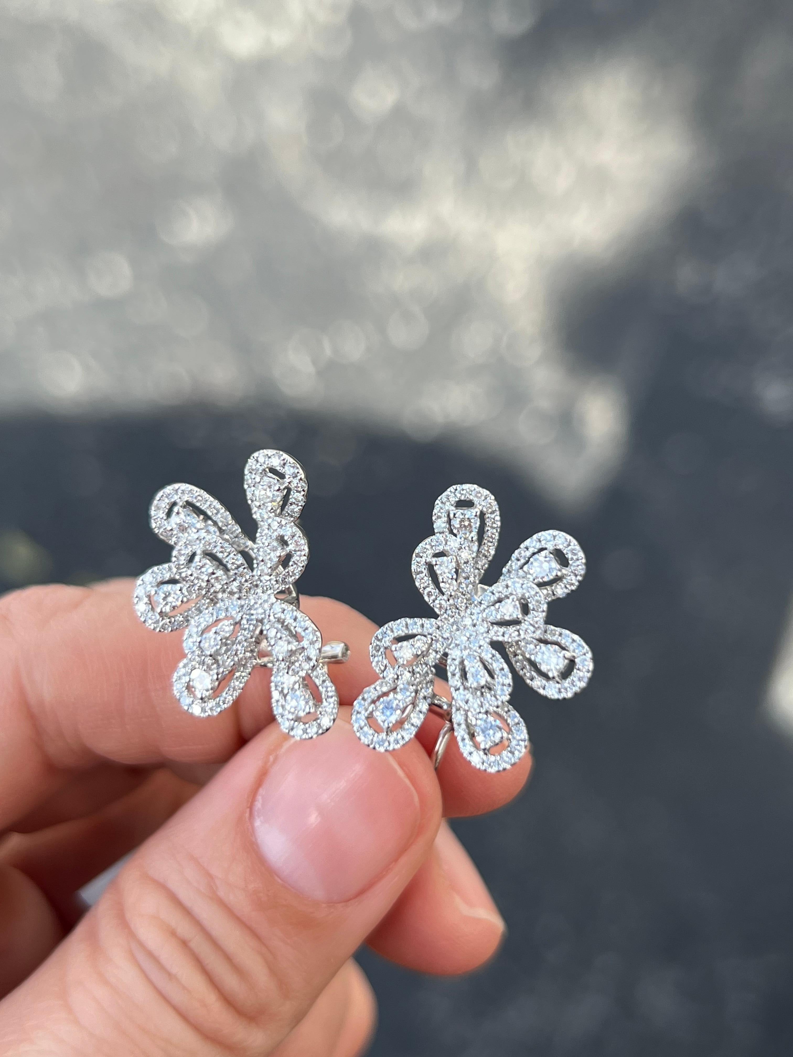 18K white gold and diamond firework design statement earrings. Beautiful for a special event,  stunning for daily use. 

Features
18K white gold
2.02 carat total weight in diamond
Post earring with clip closure
Earrings measure approx. 23 mm