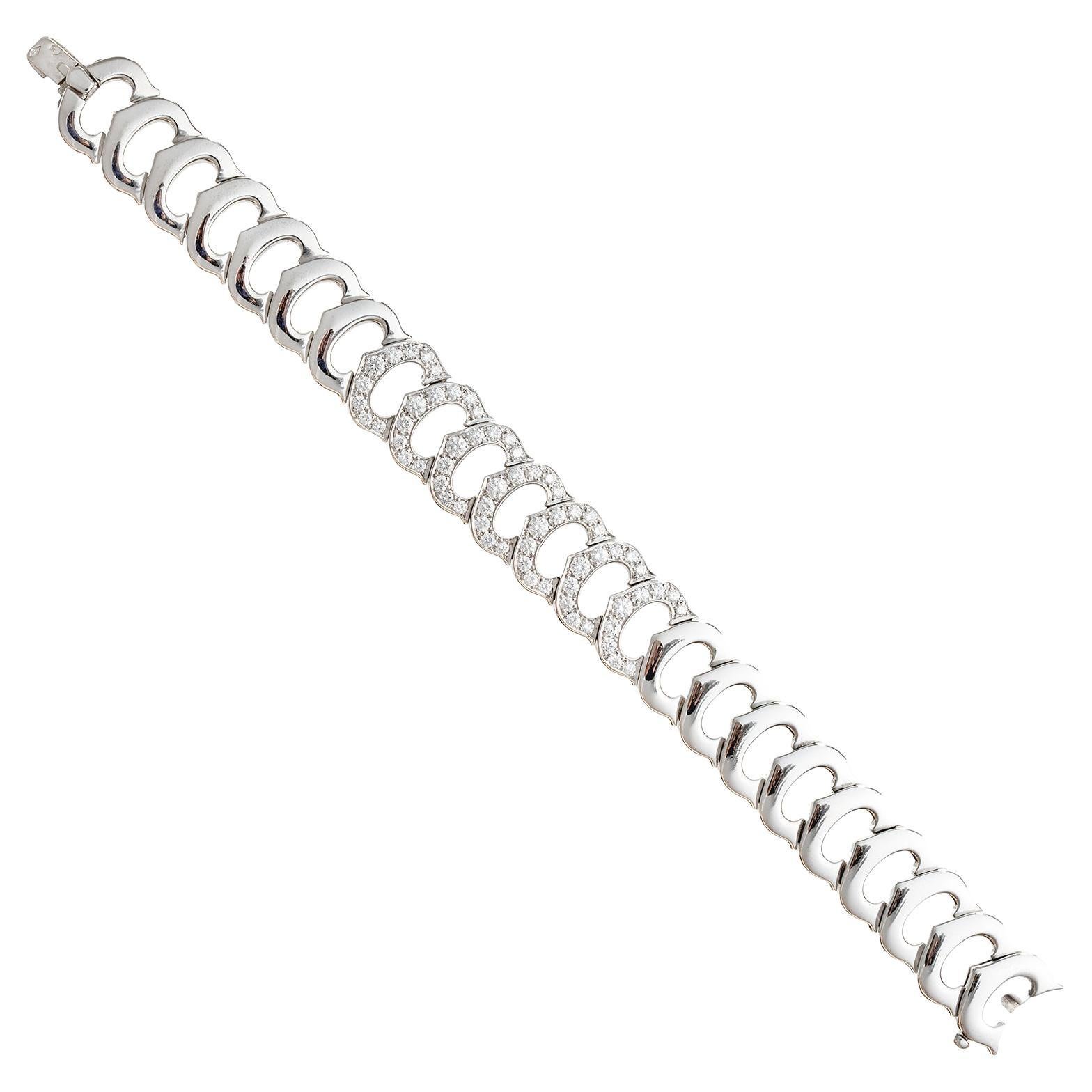 'C' de Cartier link bracelet, featuring horizontally joined 'C' logo motif links in polished 18k white gold accented by seven links at center set with round brilliant-cut diamonds.  63 diamonds weighing approximately 3.50 total carats.  Signed