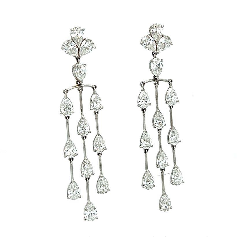 Stunning 6.05-carat diamond drop chandelier earrings in 18k white gold. Each earring is composed of 13 pear-shaped diamonds. The diamonds are G/H color, VS/ SI clarity. 
The pear shapes are prong set in three descending rows each with 3 diamonds.