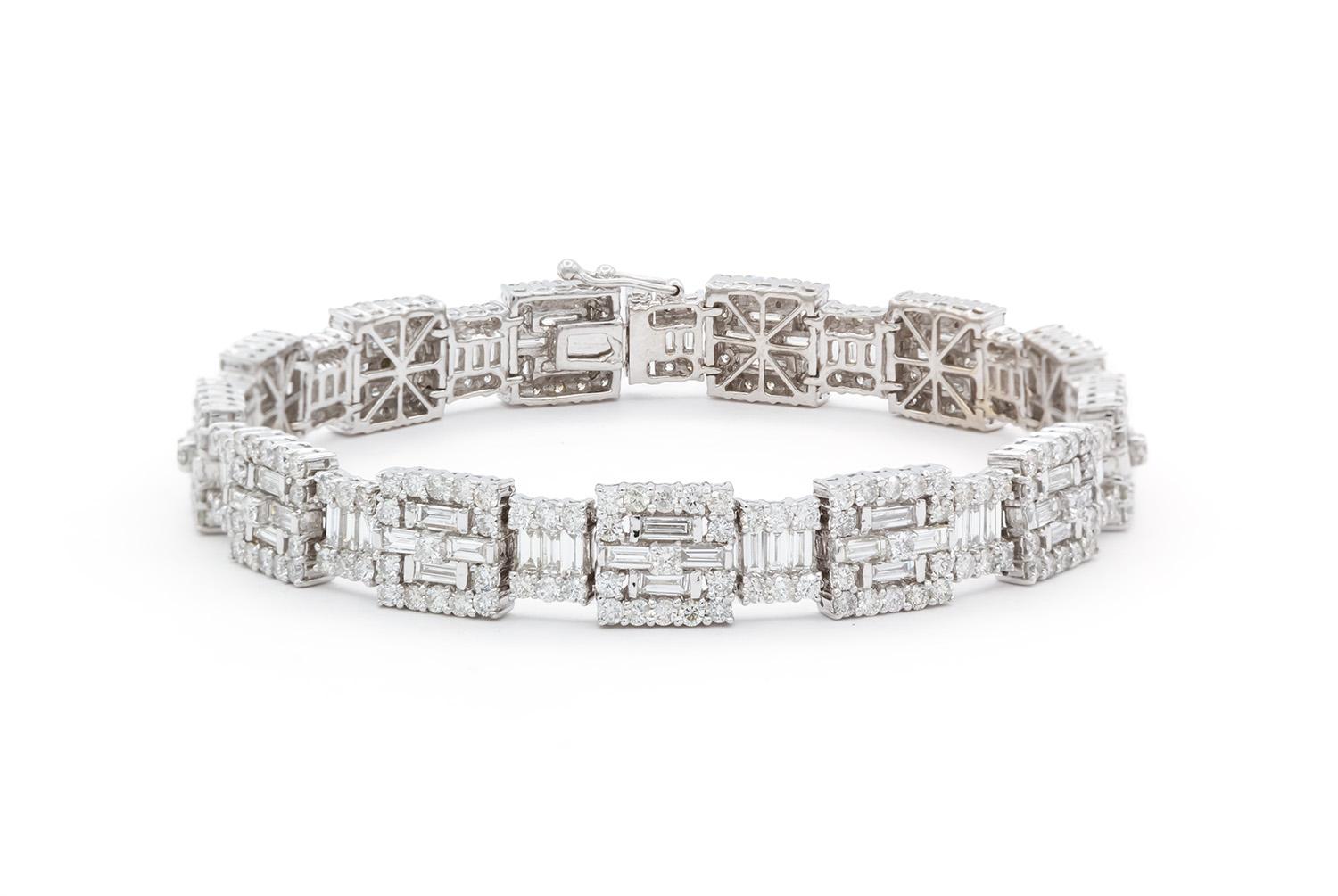We are pleased to present this stunning White Gold Diamond Contemporary Baguette Diamond Tennis Line Bracelet. It features an estimated 8.40ctw G-H/VS-SI baguette & round brilliant cut diamonds all securely set in this breathtaking 18k white gold