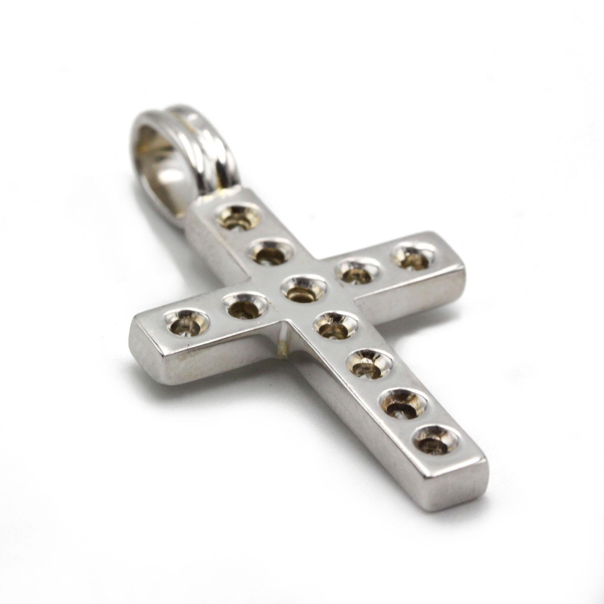 This striking 18K white gold cross pendant presents a clean, contemporary silhouette set with eleven brilliant-cut round diamonds totaling approximately 2.00 carats G VS. The diamonds are invisible-set into the solid cross form, allowing the sparkle