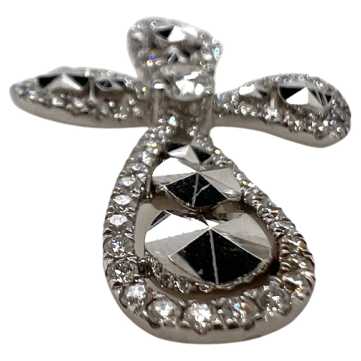 18k white gold diamond cross with diamond cut gold for an extra  unique appearance.  The round diamonds form along the exterior of the cross and also has a 1 single diamond in the center.  The diamond cut gold also comprises the interior to give the