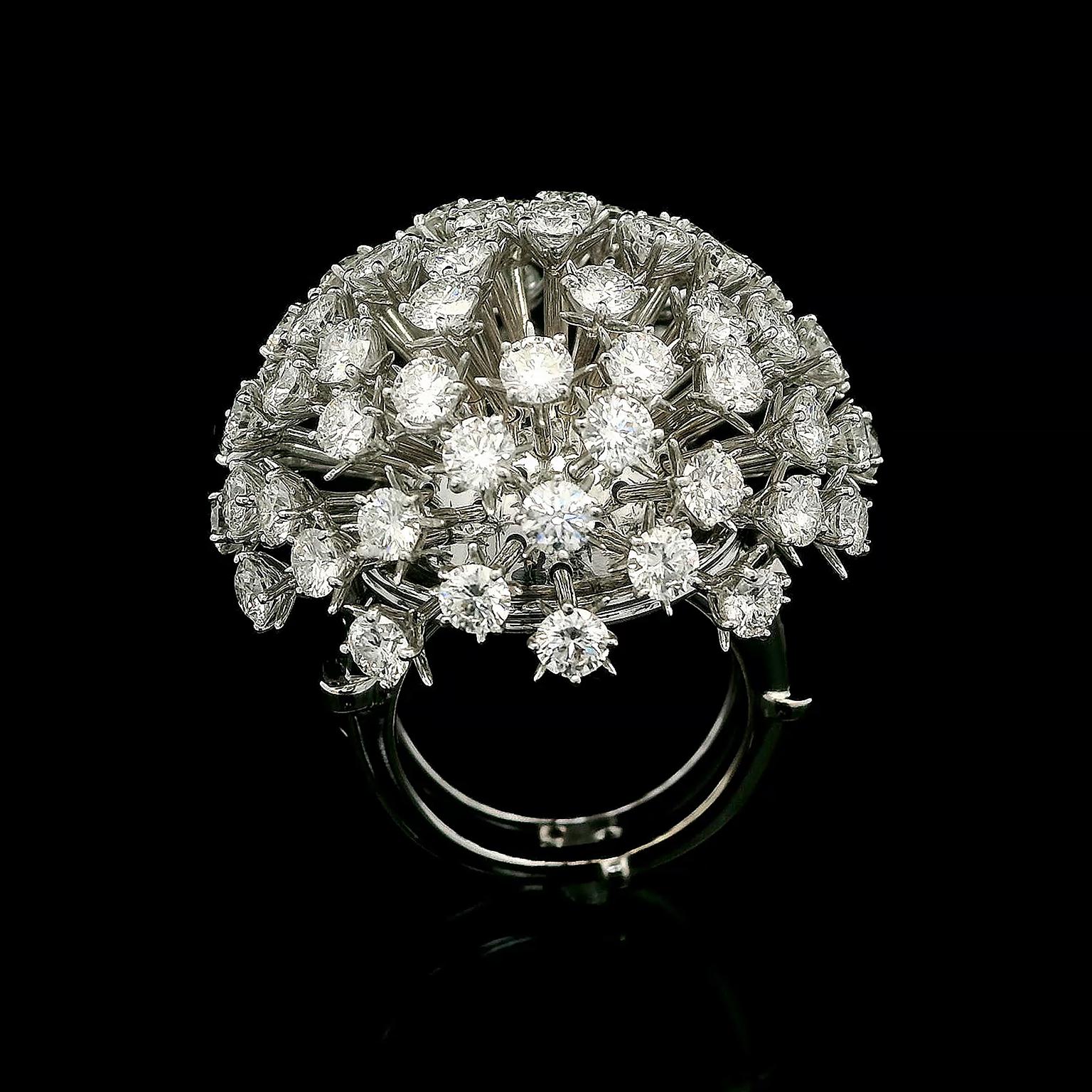 A blooming dandelion comes to life in white diamonds and 18k white gold for this arresting ring. Slender rays of flexible 18k white gold wire extend as the head of the flower, while a single brilliant cut diamond held by round prongs adorns each