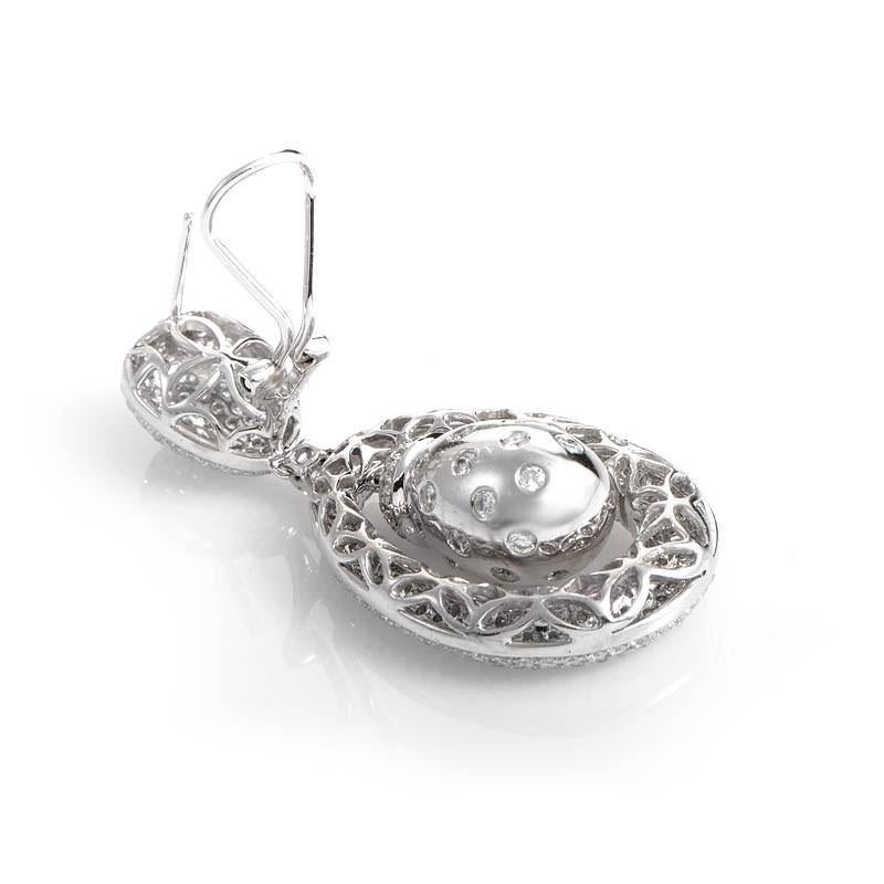 This pair of earrings are lovely and unique. They are made of 18K white gold and are studded with ~7.30ct  of diamonds.