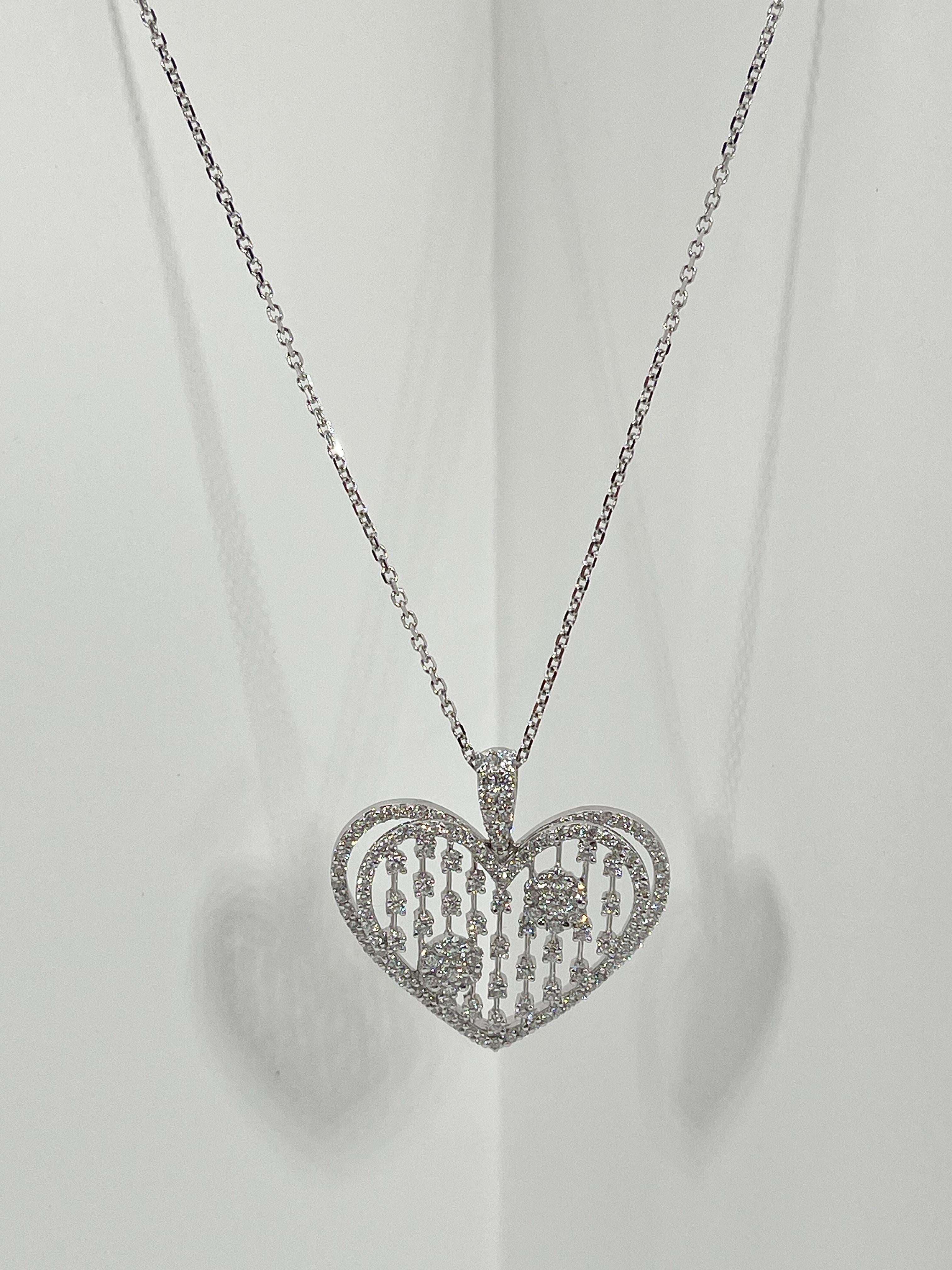 This one of a kind 18k white gold double open heart with round and princess cut diamonds has a total CTW of 3 and are vs2 G color. Necklace is 18 inches in length and the pendant measures 34.3 x 22.2 mm. The total weight of the necklace is 13.6