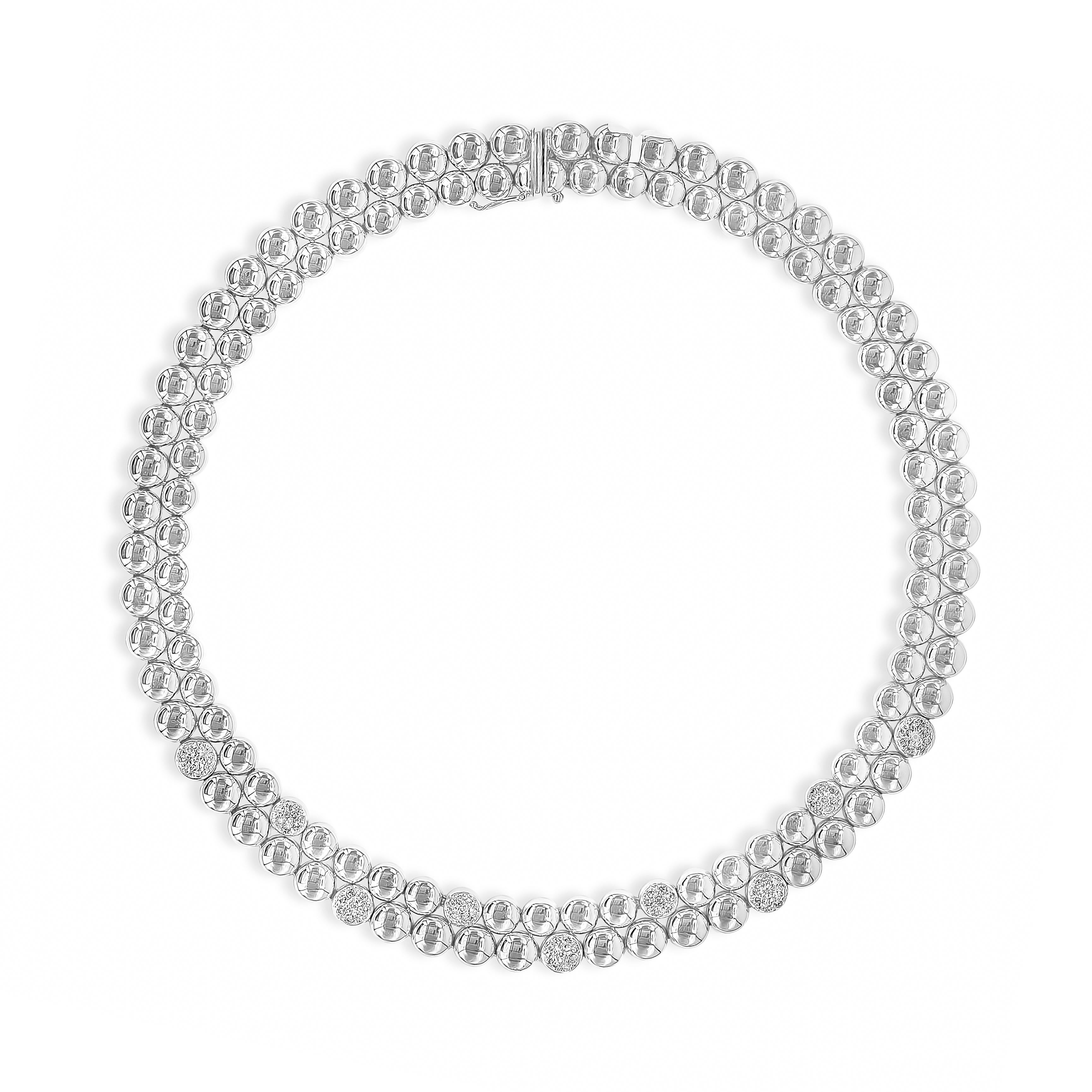 A stylish necklace showcasing two rows of 18K white gold balls, accented with round brilliant diamonds. Diamonds weigh 1.06 carats total, G color and VS in clarity. Weighing 66.57 grams, 15 inches in length and made in white gold.