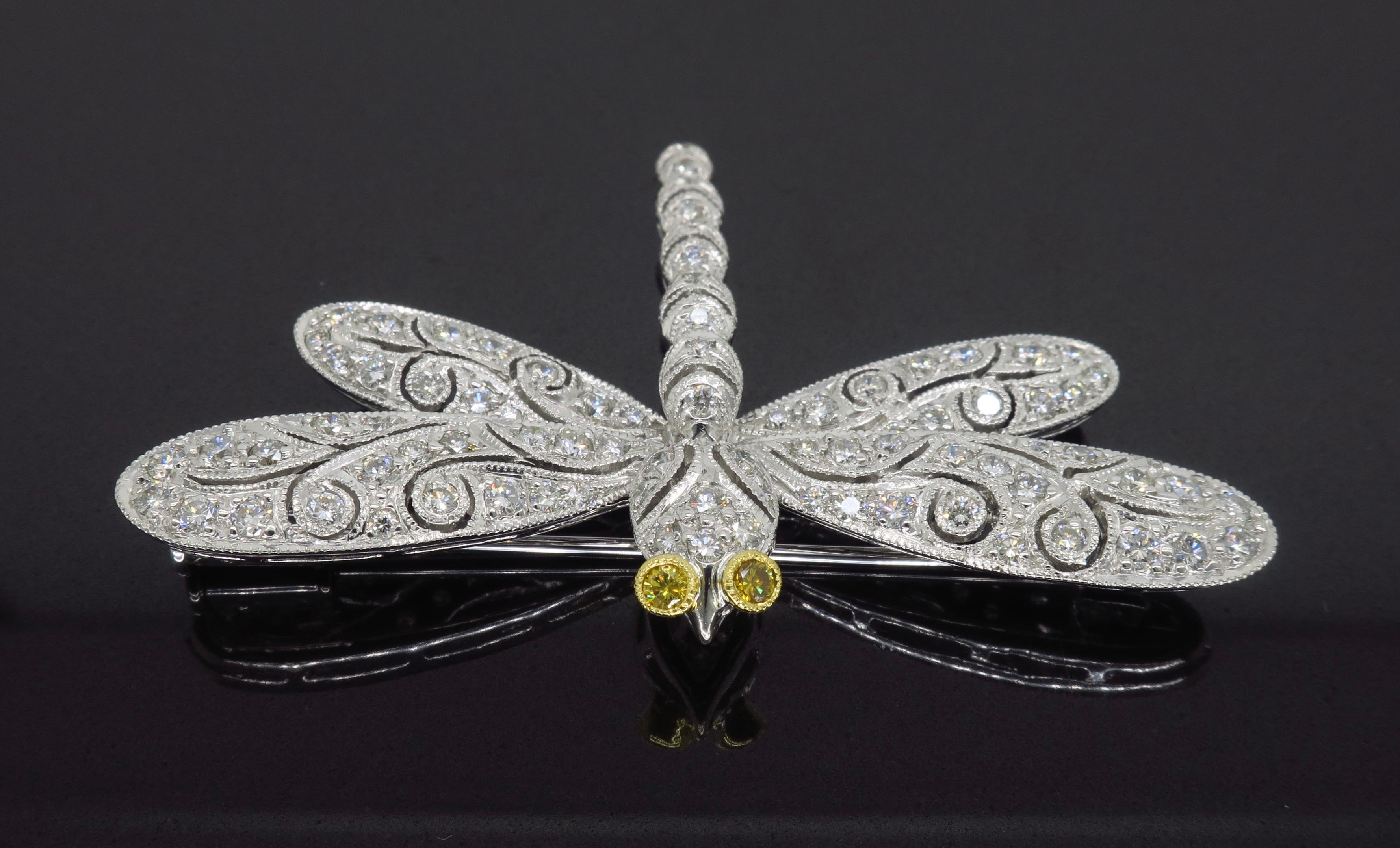 Ornate fire fly diamond brooch crafted in 18k white gold. 

Diamond Carat Weight: Approximately 1.30CTW
Diamond Cut: Round Brilliant Cut Diamonds
Color: Average G-J and Two Yellow Diamond Eyes
Clarity: Average VS-I
Metal: 18K White Gold