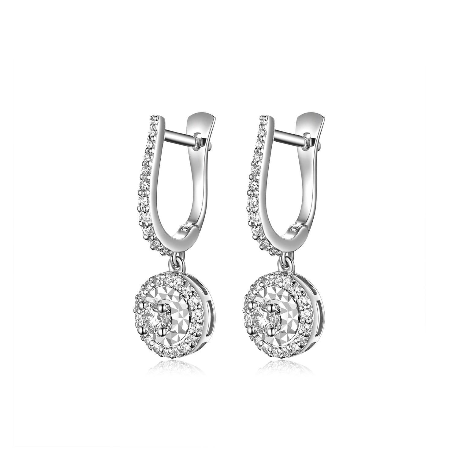 This earrings feature two 0.11 carat diamond at the center of each earring, assented with 0.48 carat of small diamonds. The center diamond is set with an illusion setting making the center part larger. Great for everyday-use. Earrings are set in 18