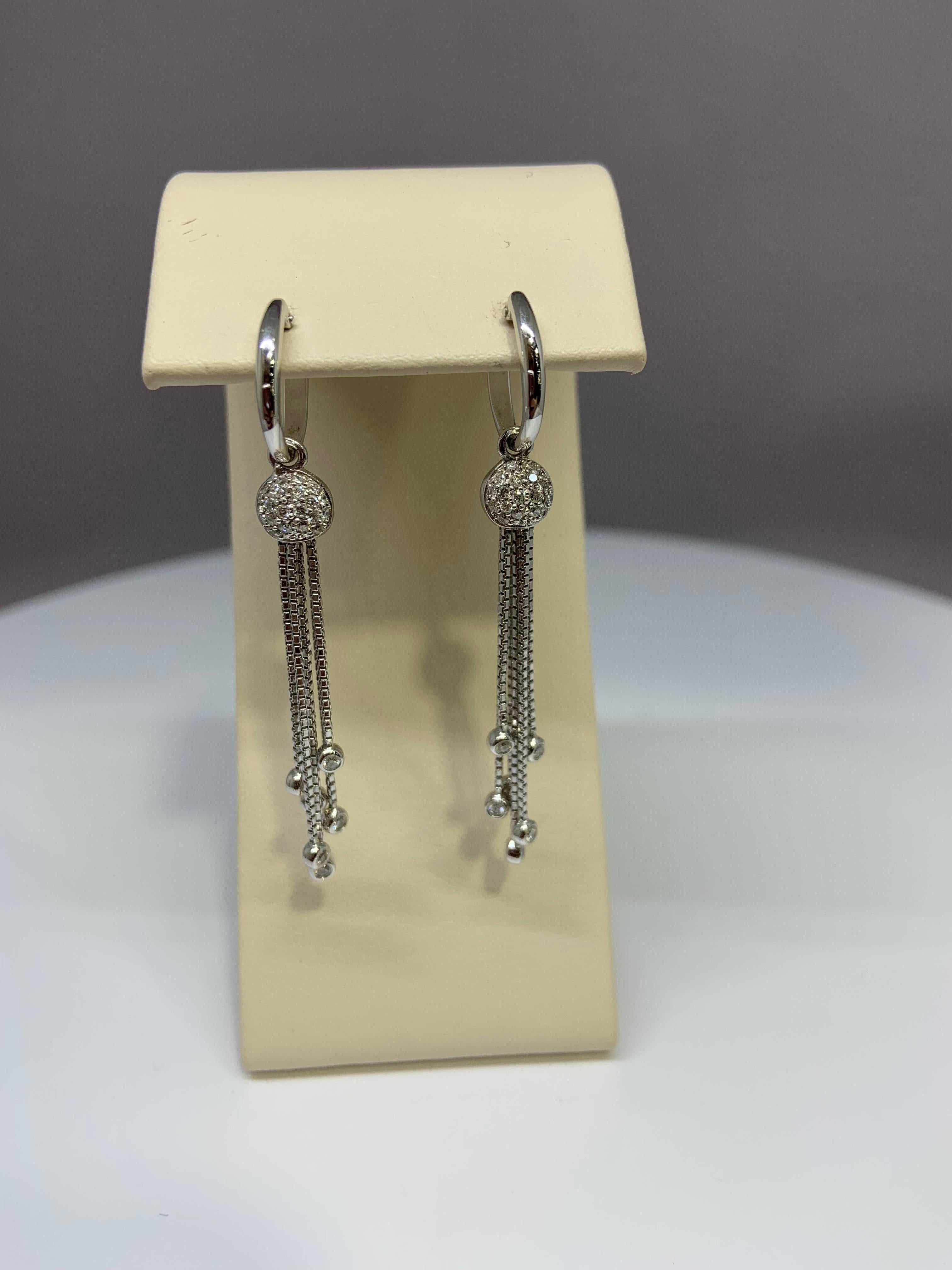 These gorgeous diamond drop earrings are made of 18k white gold. These earrings are estimated to hold just under 1/2 carat total weight of genuine diamonds. 