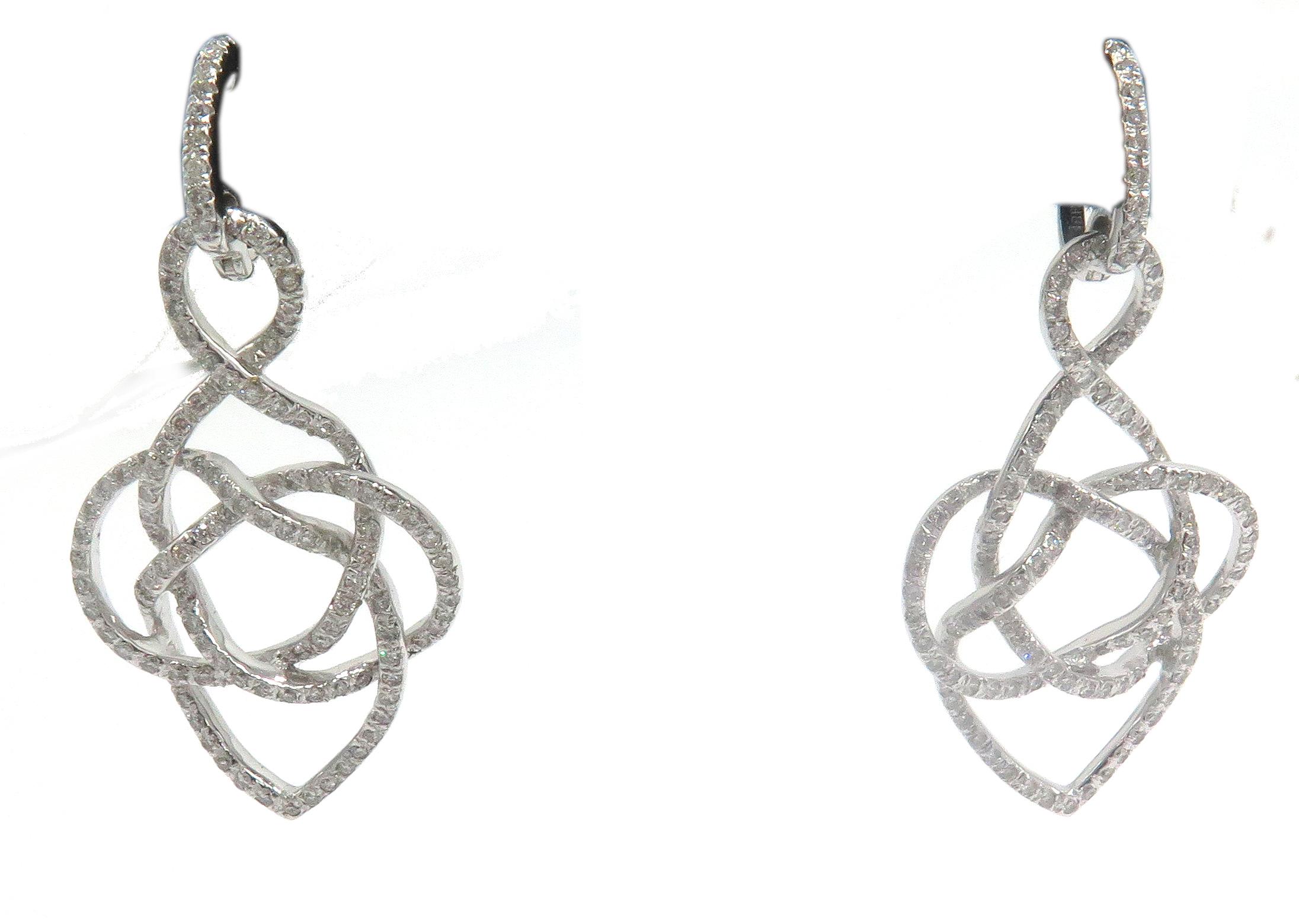 Beatiful, 18k white gold earring earrings. This beautiful pair of earrings feature a lever back and is showered with beautiful round diamonds going through the design of the these beautiful earrings. These, lovely earring also have a matching