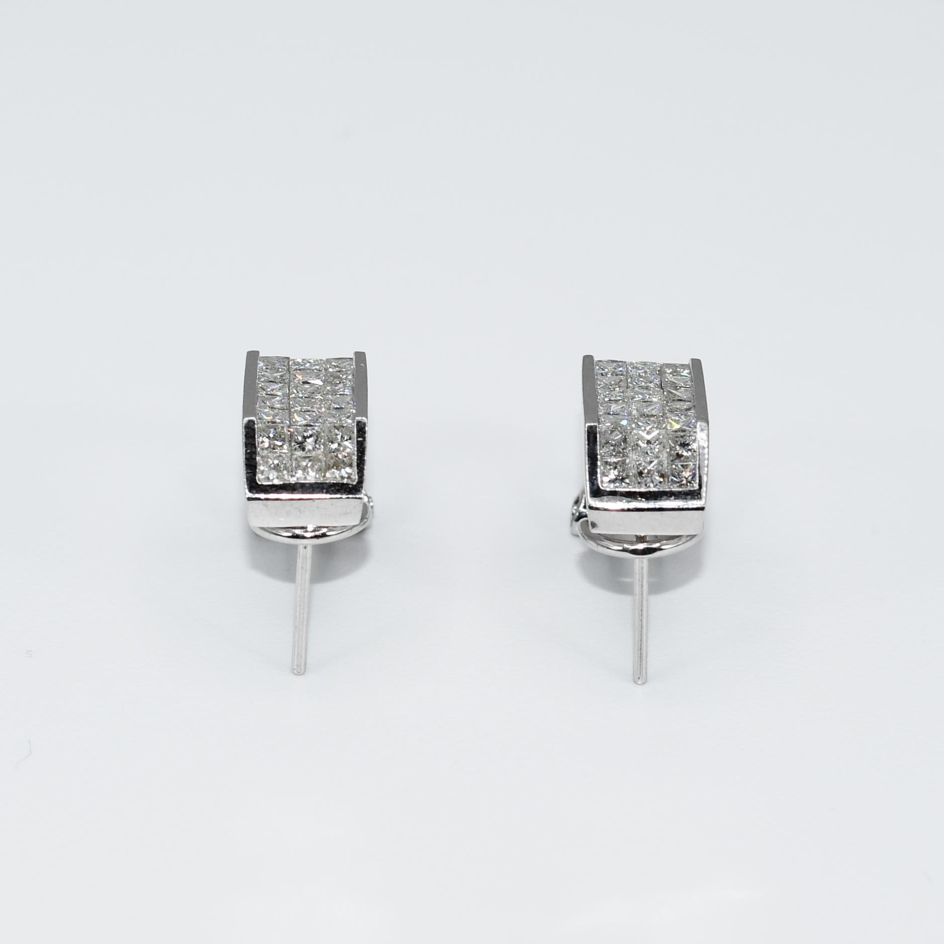 Ladies 18k white gold and diamond earrings.
Stamped 18k, 750 , 1.88 and weighs 6.9 grams.
The diamonds are princess cuts, 1.88 total carats, G,H, i color range, Vs clarity.
The three rows of diamonds are invisible set.
The earring measure 17mm in